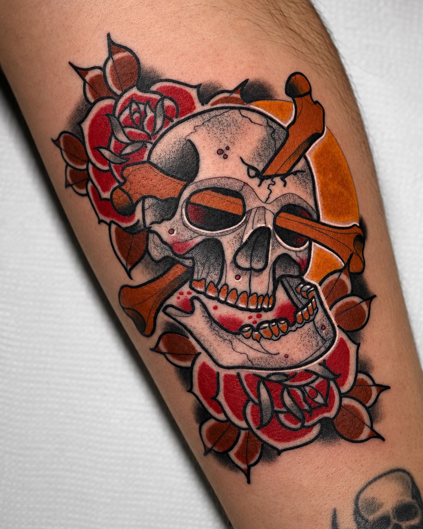 Skull and roses American traditional tattoo on the forearm by Todd Showdown