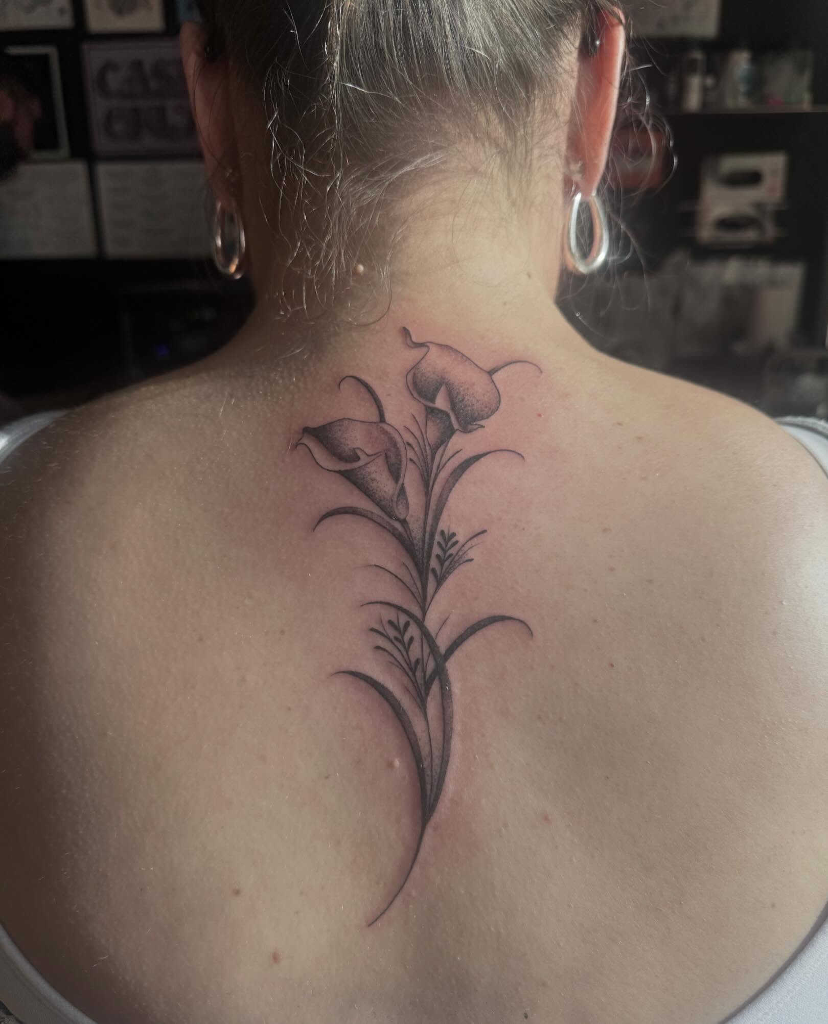 Calla lilies black and grey tattoo on the back by Tattoo, San Diego, California
