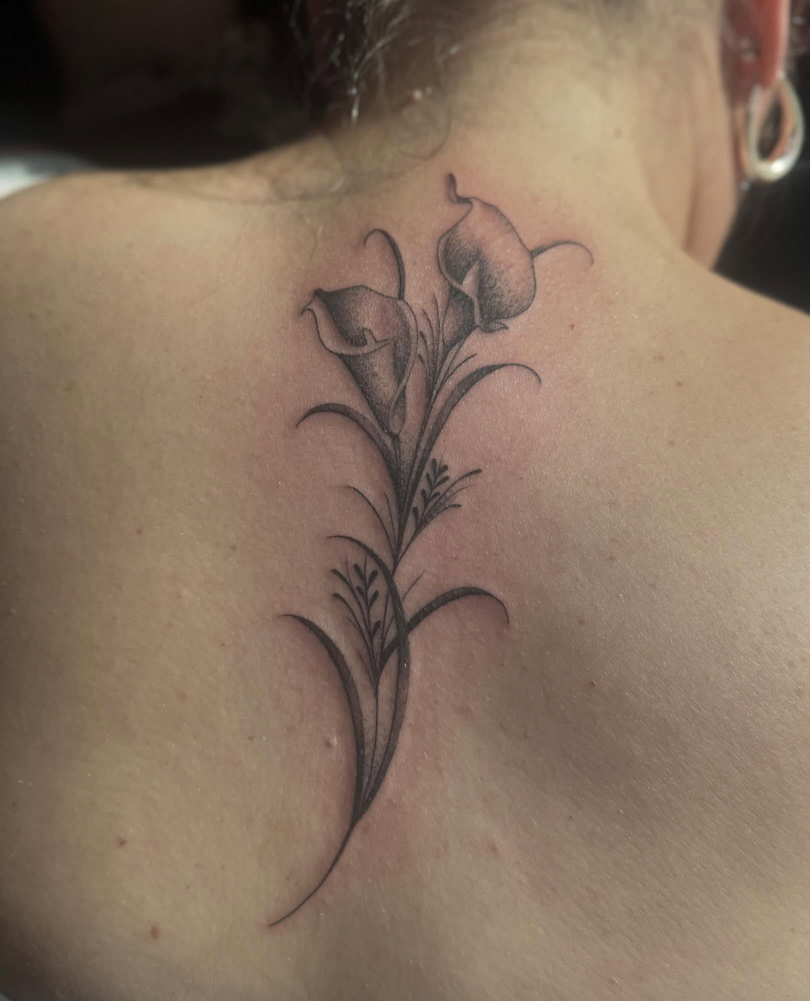 Calla lilies black and grey tattoo on the back by Tattoo, San Diego, California