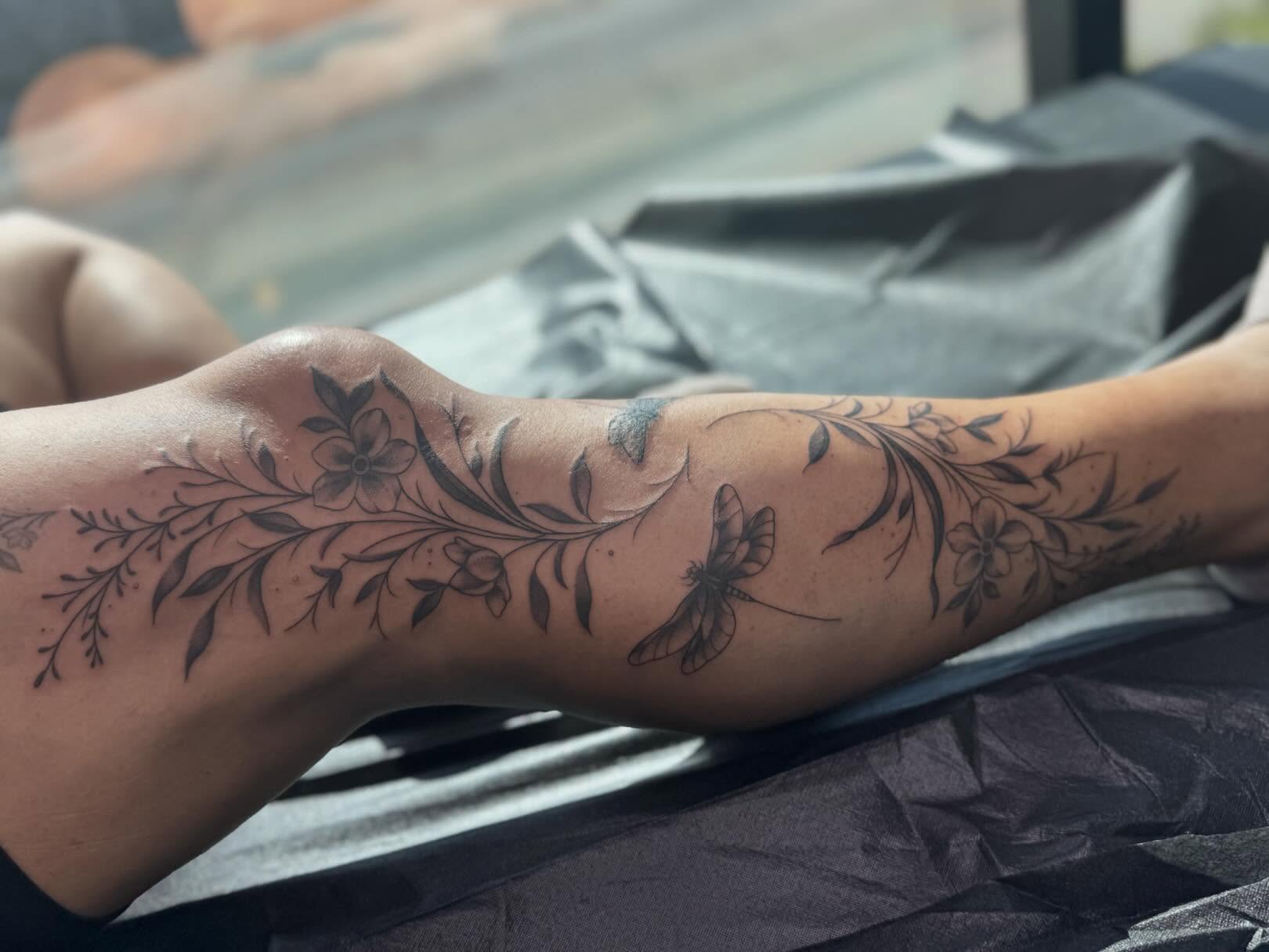 Floral and dragonfly black and grey tattoo on the forearm by Tattoo, San Diego, California