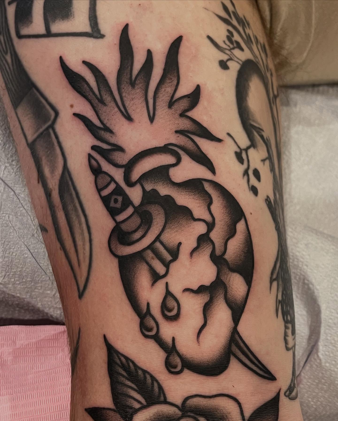 Heart with bomb black and grey tattoo on the forearm by Kayla Gibson, Portland, Oregon