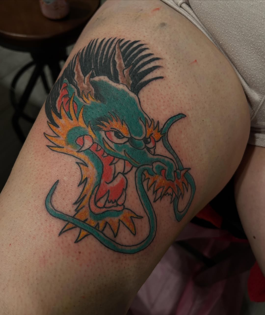 Dragon American traditional tattoo on the thigh by Stogie Tony