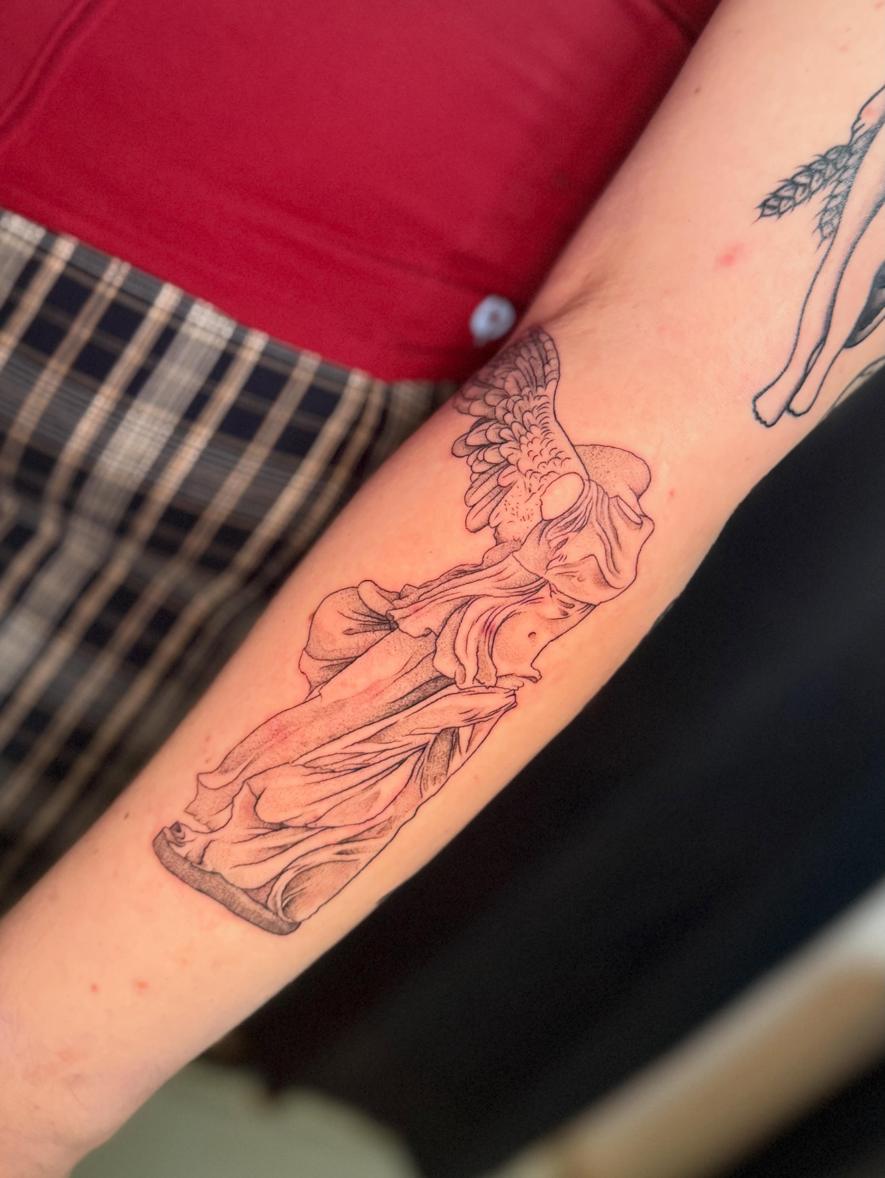 Statue black and grey tattoo on the forearm by Olivia, Royal Oak, Michigan