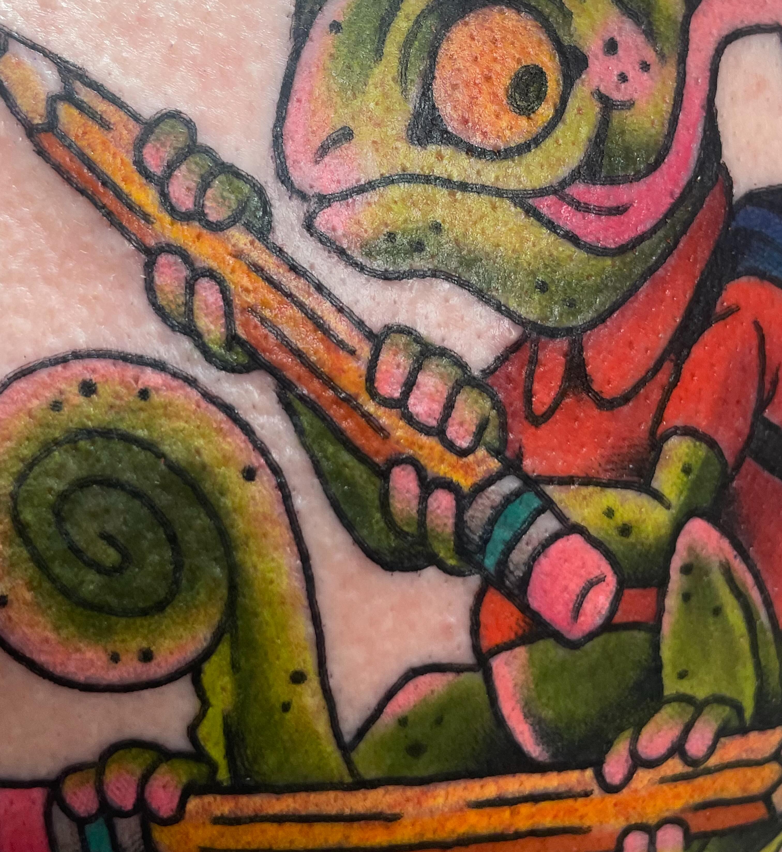 Frog playing flute American traditional tattoo on the forearm by Eric (EK) Kuldell