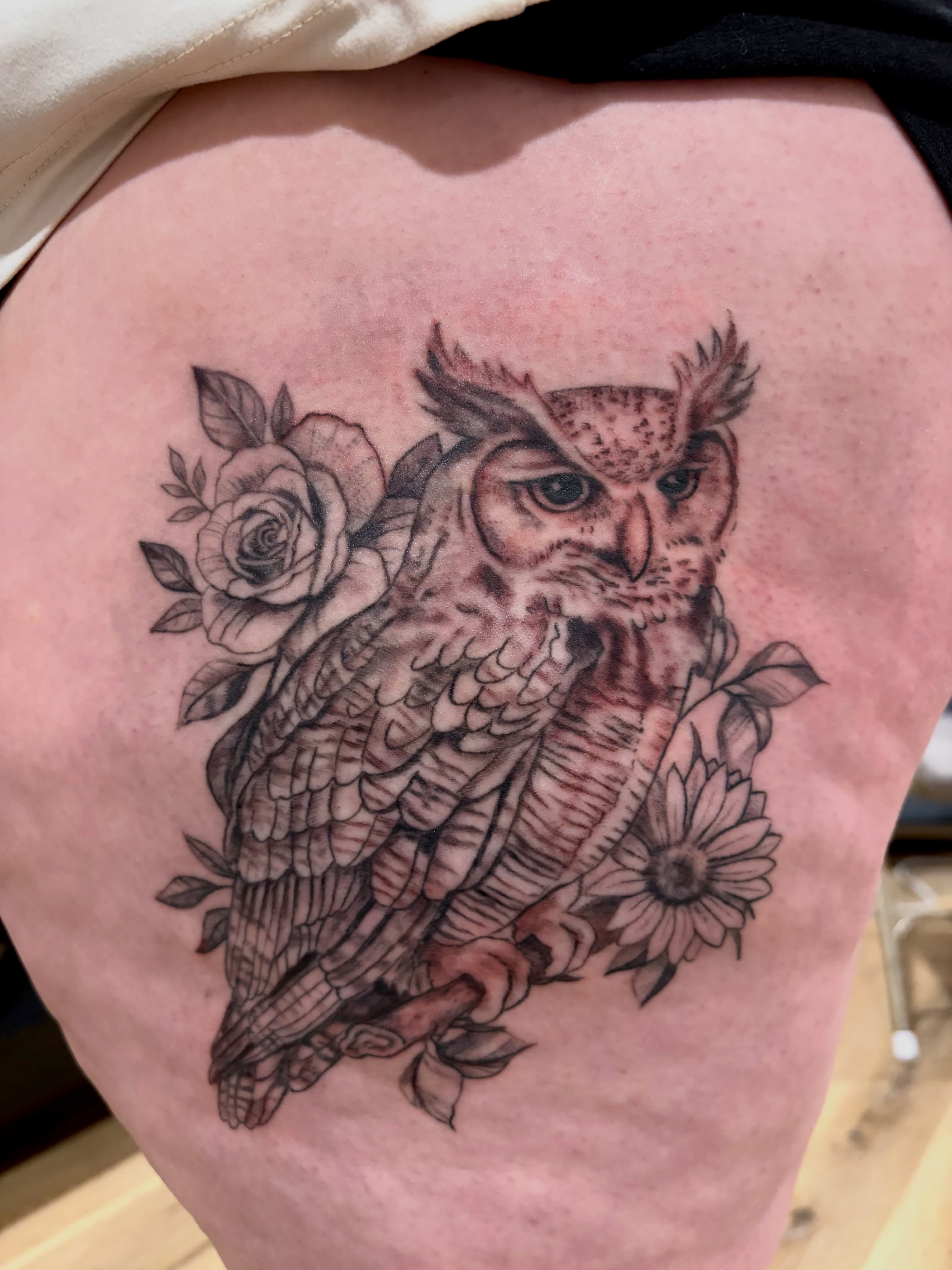 Owl black and grey tattoo on the thigh by Emily, Monticello, Iowa