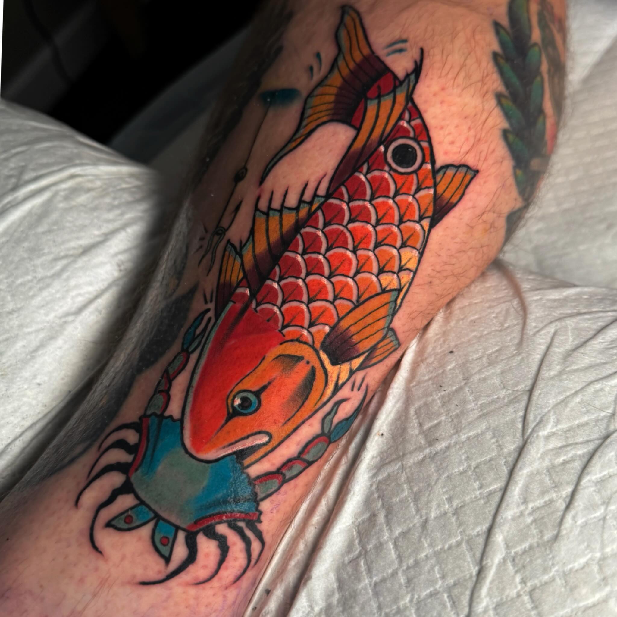 Koi fish American traditional tattoo on the forearm by Dylan Walker