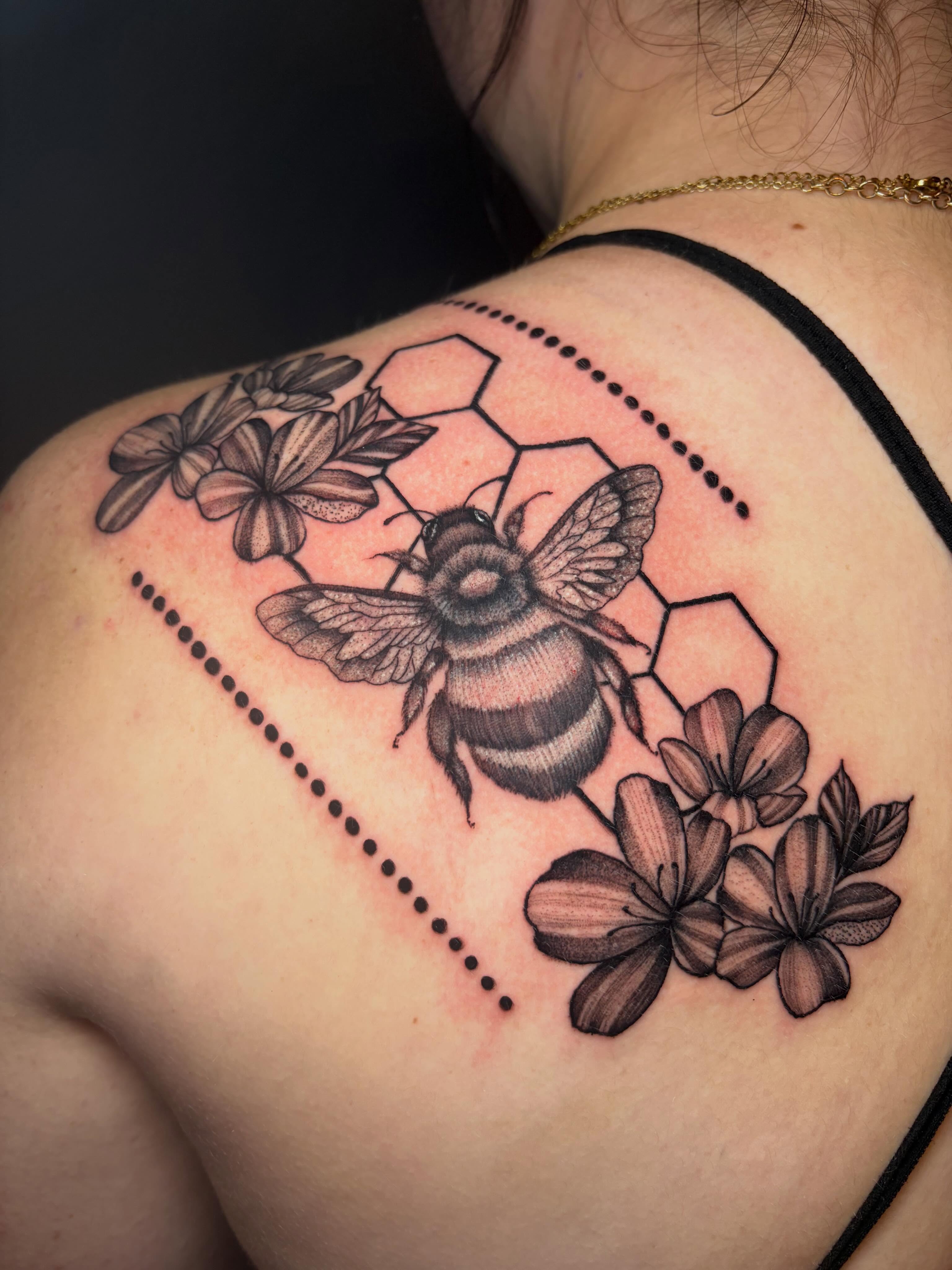 Bee and flowers dotwork tattoo on the shoulder by Rachel Sellers