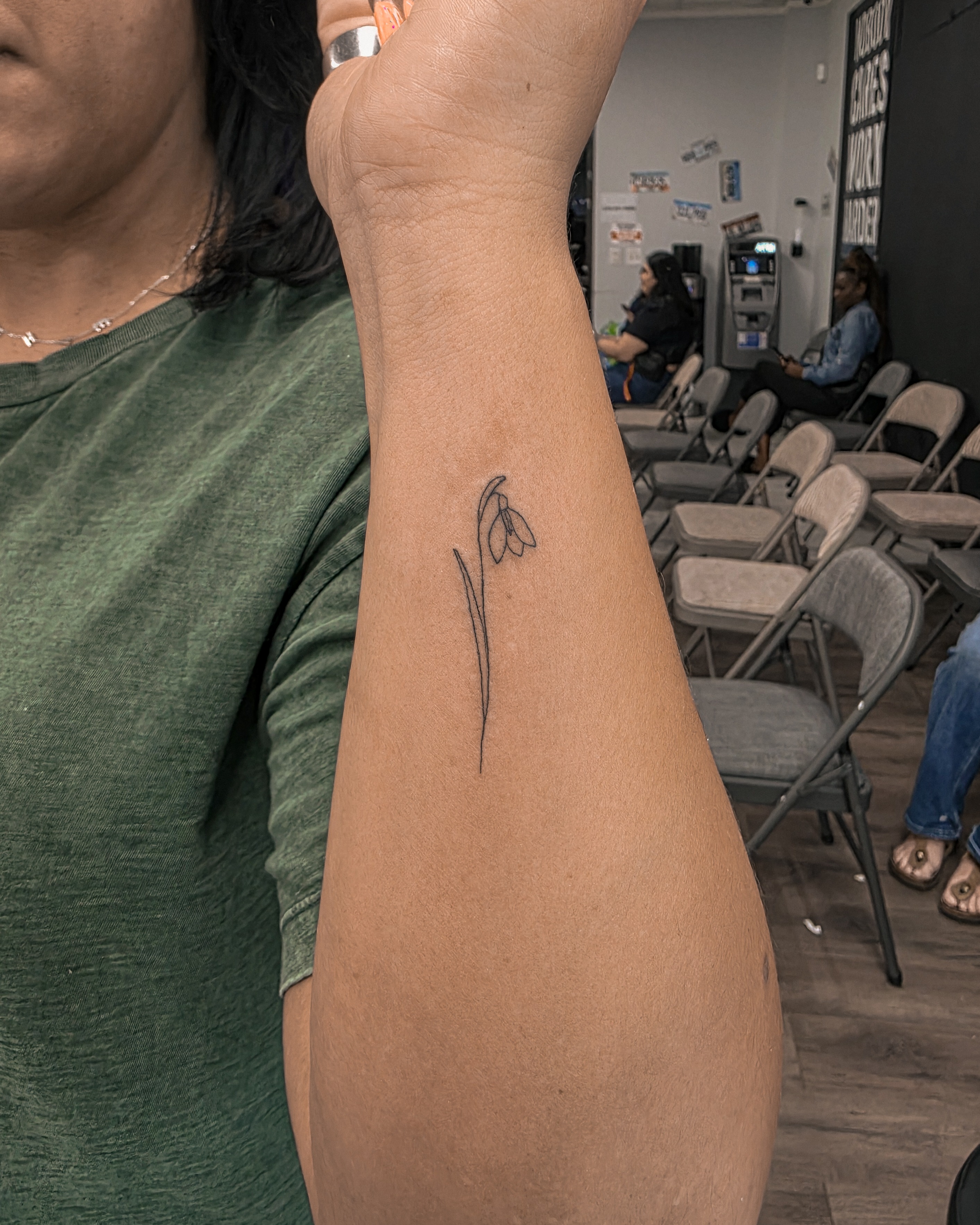 Snowdrop minimalist tattoo on the forearm by Richmond tattoo shop, Richmond, Texas
