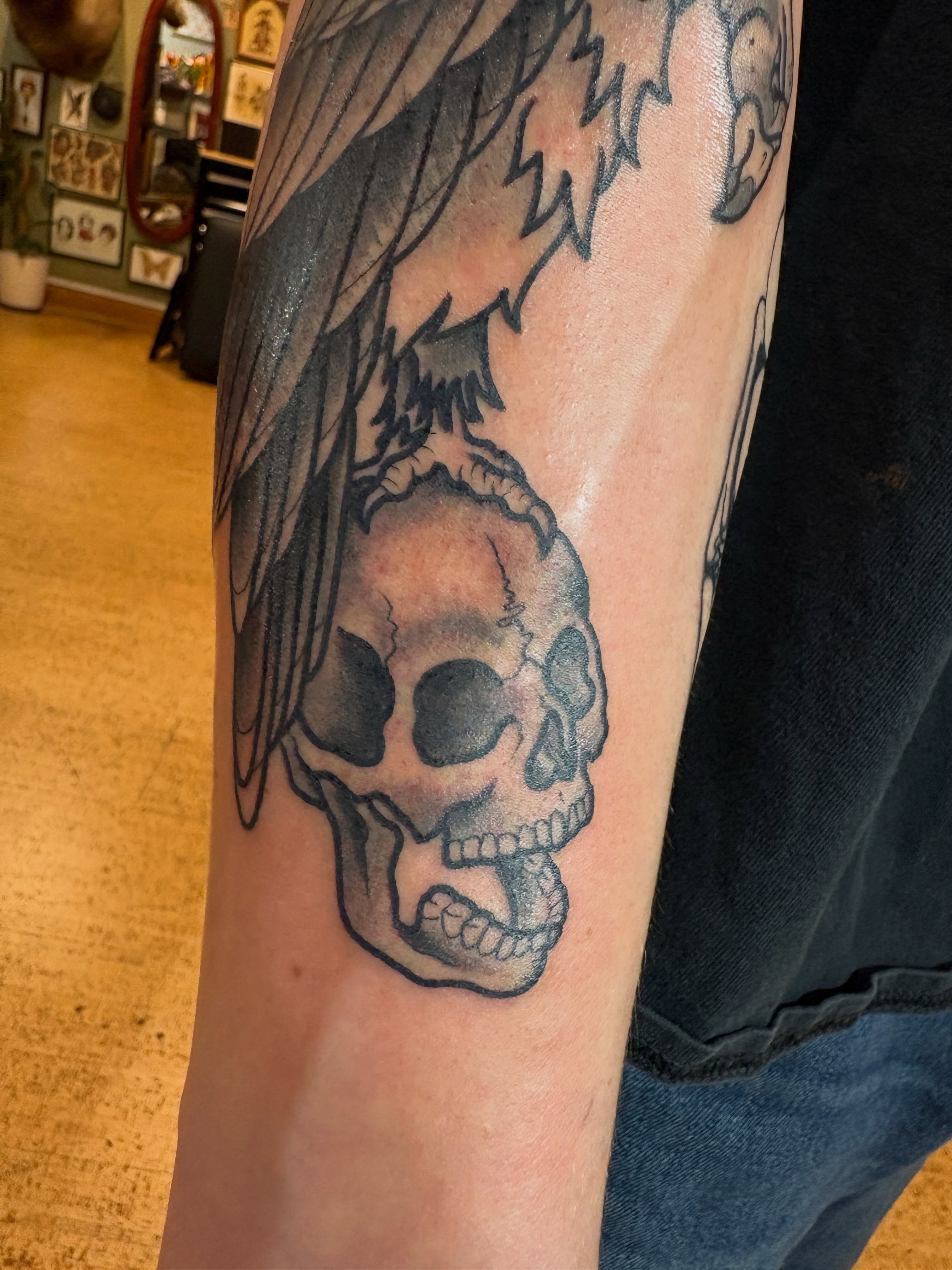 Skull with wings realism tattoo on the forearm by Kimber Teatro, Portland, Oregon
