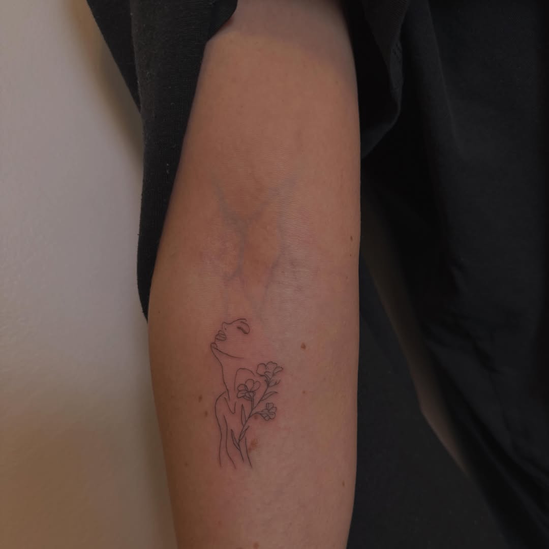 Woman with flowers fine line tattoo on the forearm by Lexie Decker, Canton, Ohio