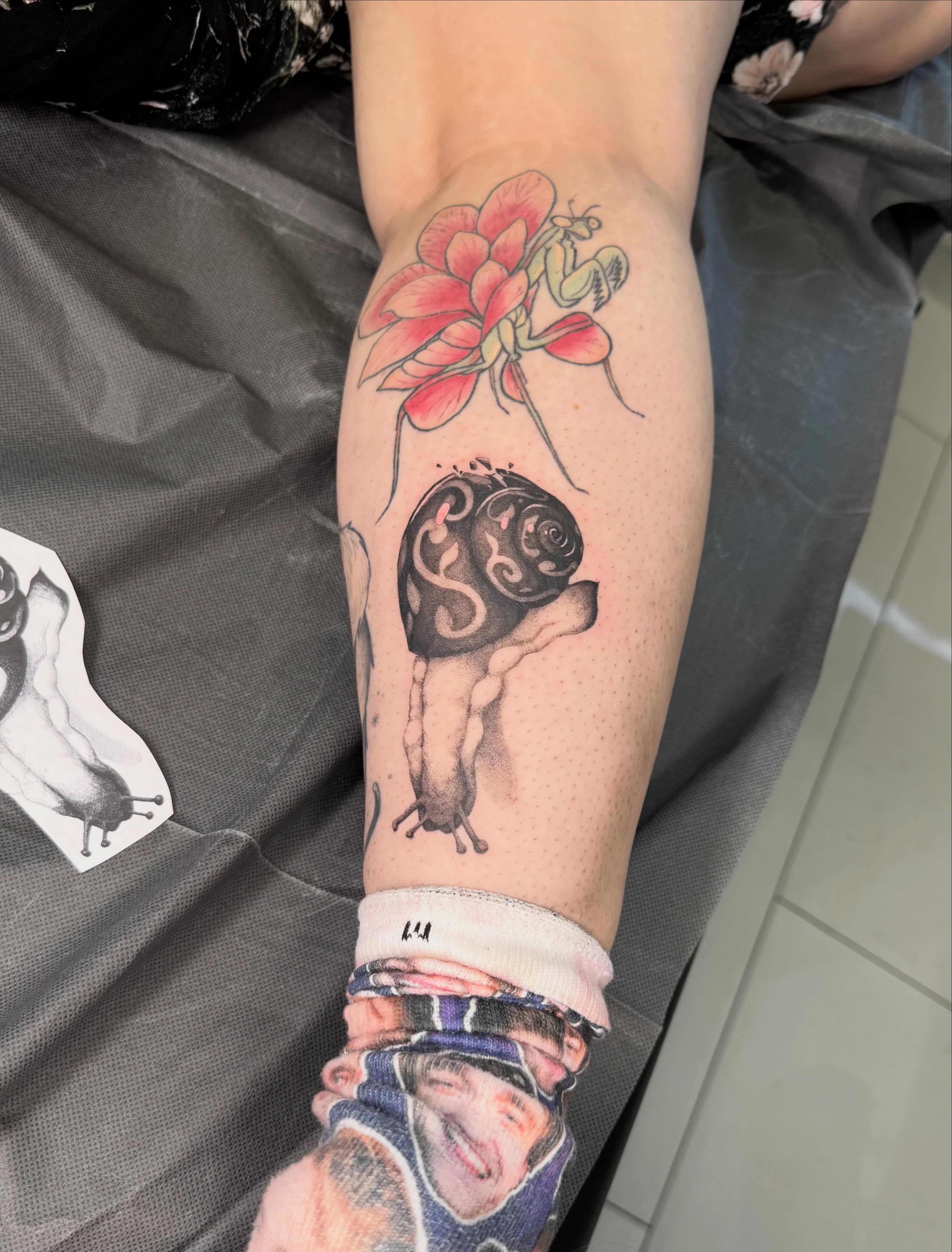 Snail and flower dotwork tattoo on the forearm by Andrew Flatts