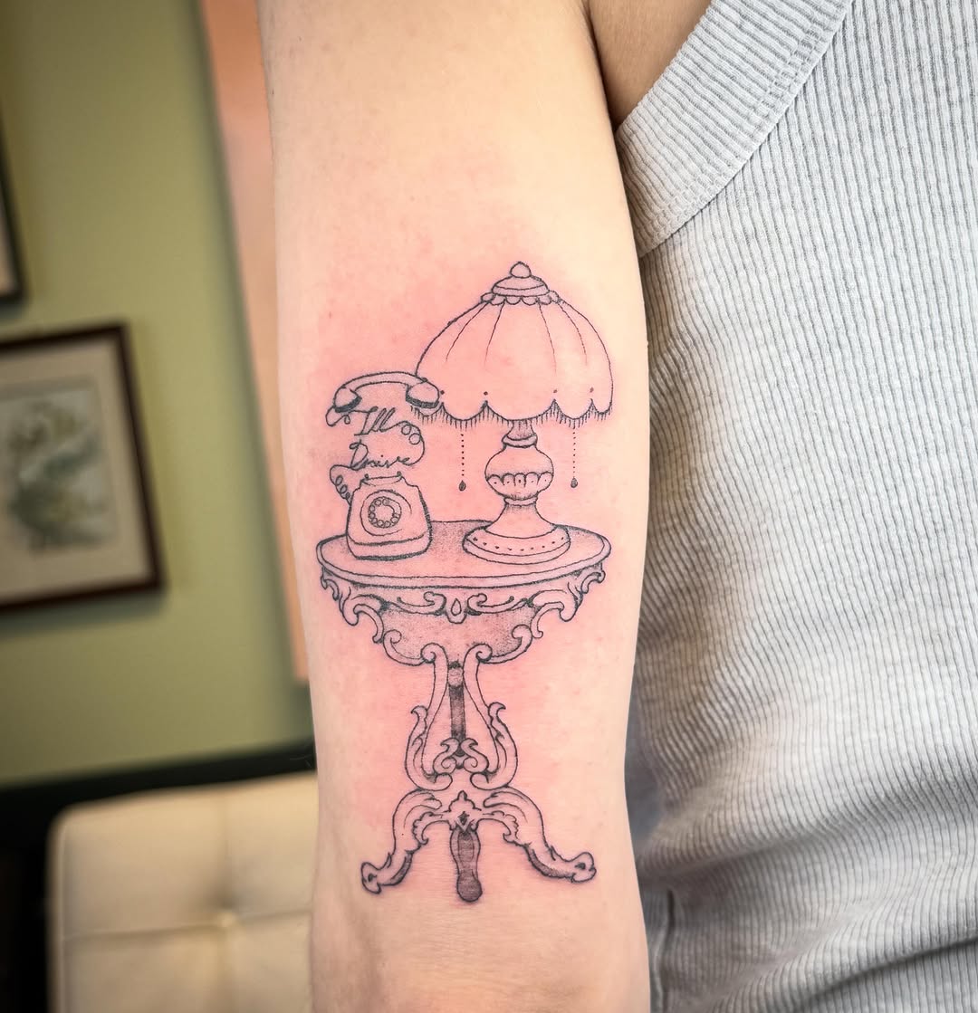 Table with lamp and telephone minimalist tattoo on the forearm by Taytum Marsing, Salt Lake City, Utah