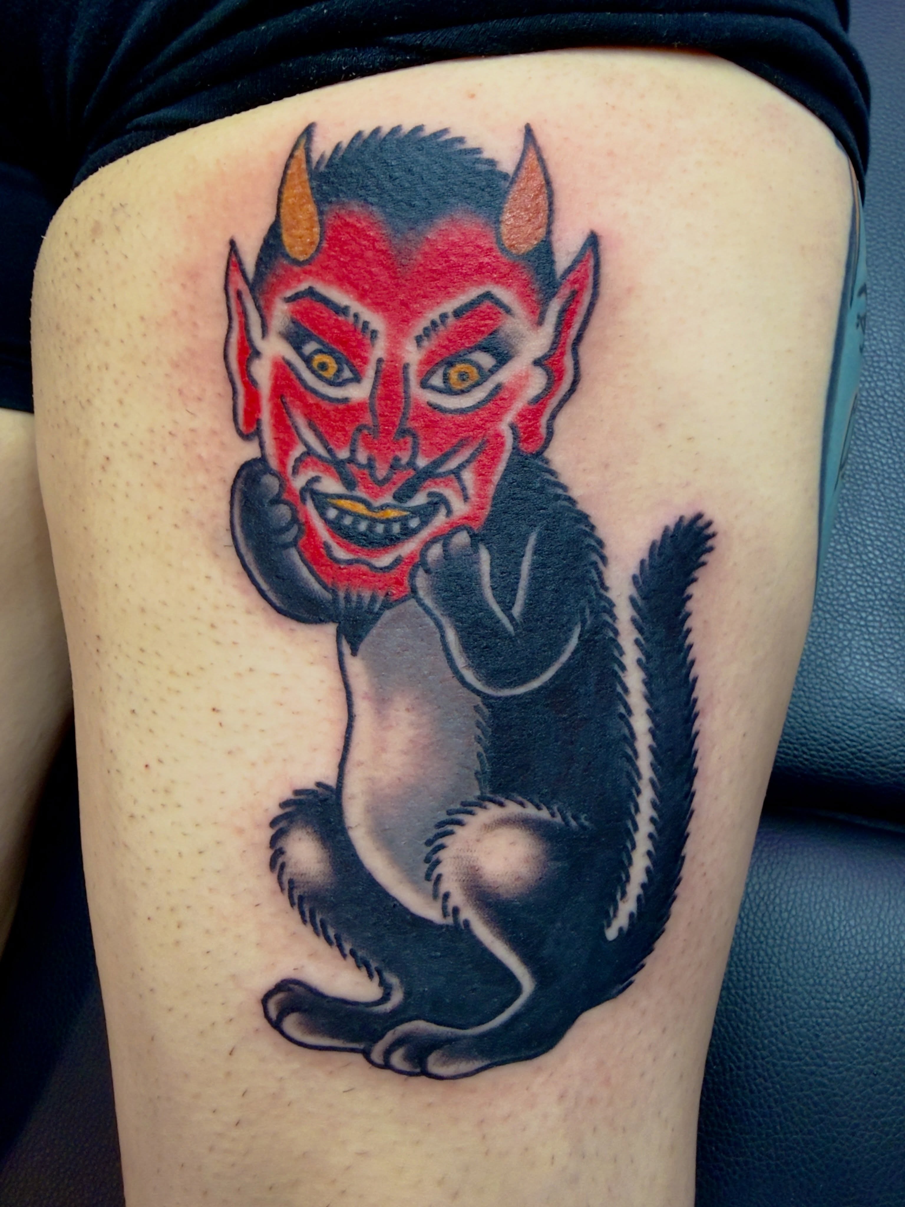 Devil American traditional tattoo on the thigh by Jimmy Kelley