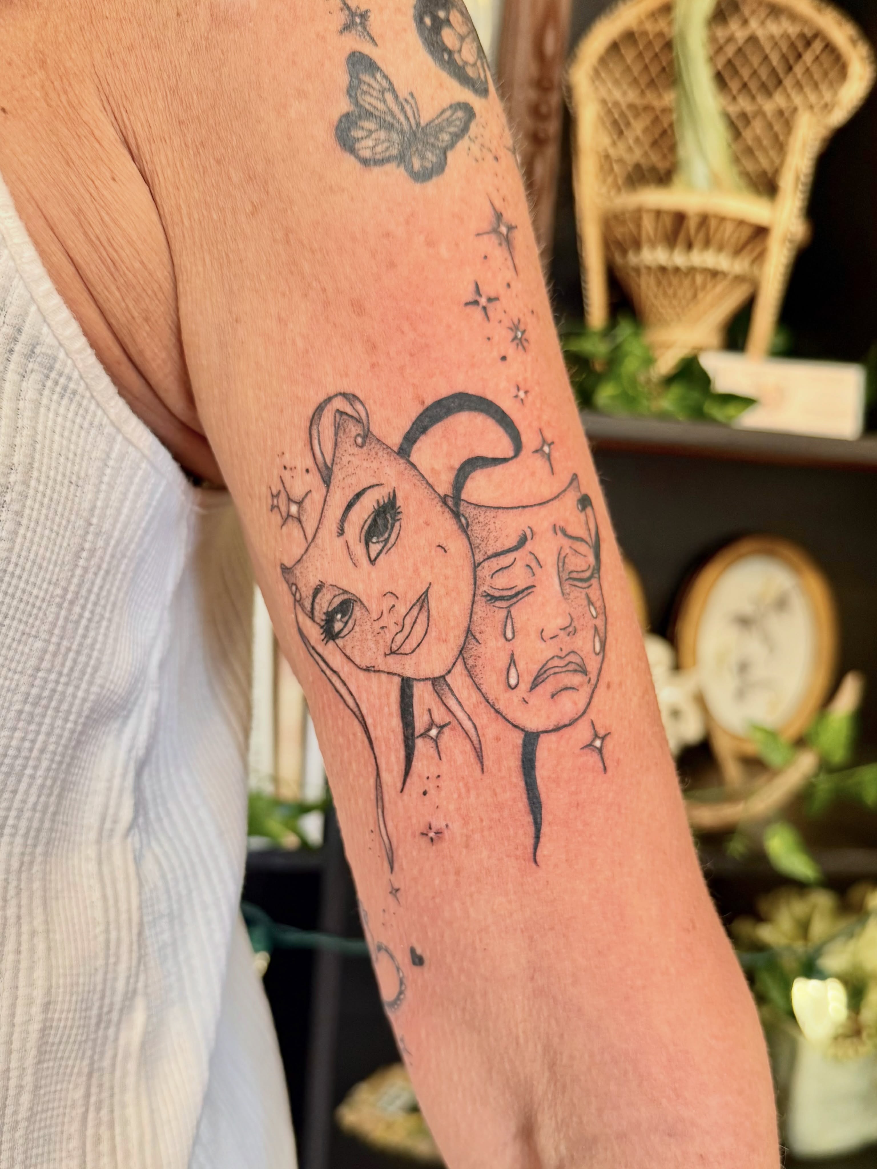 Sun and moon dotwork tattoo on the forearm by Haley Bates