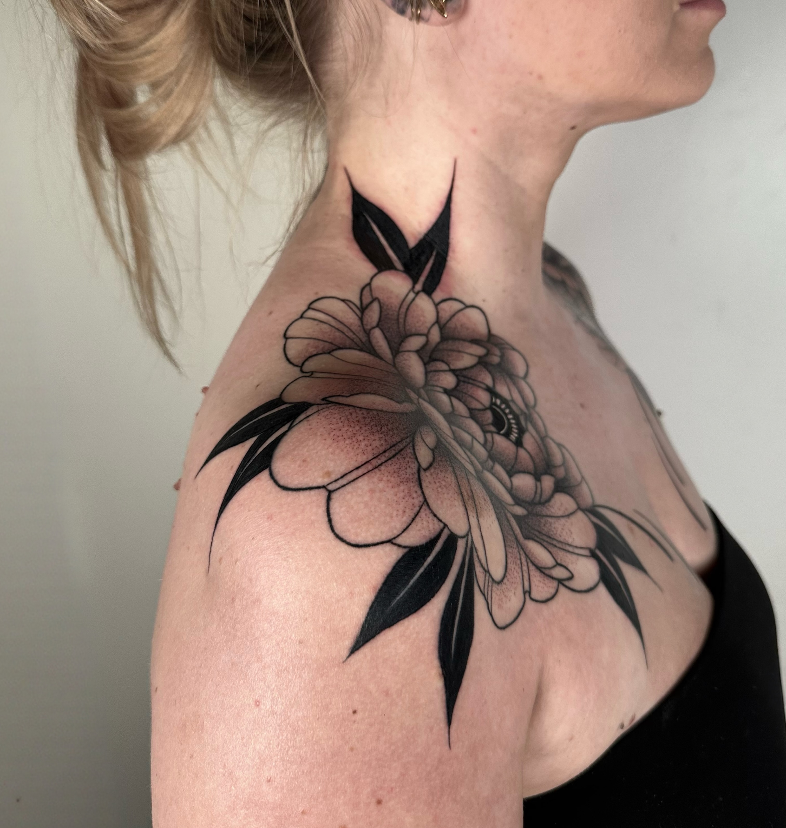 Flower black and grey tattoo on the shoulder by Brooklyn Bailey
