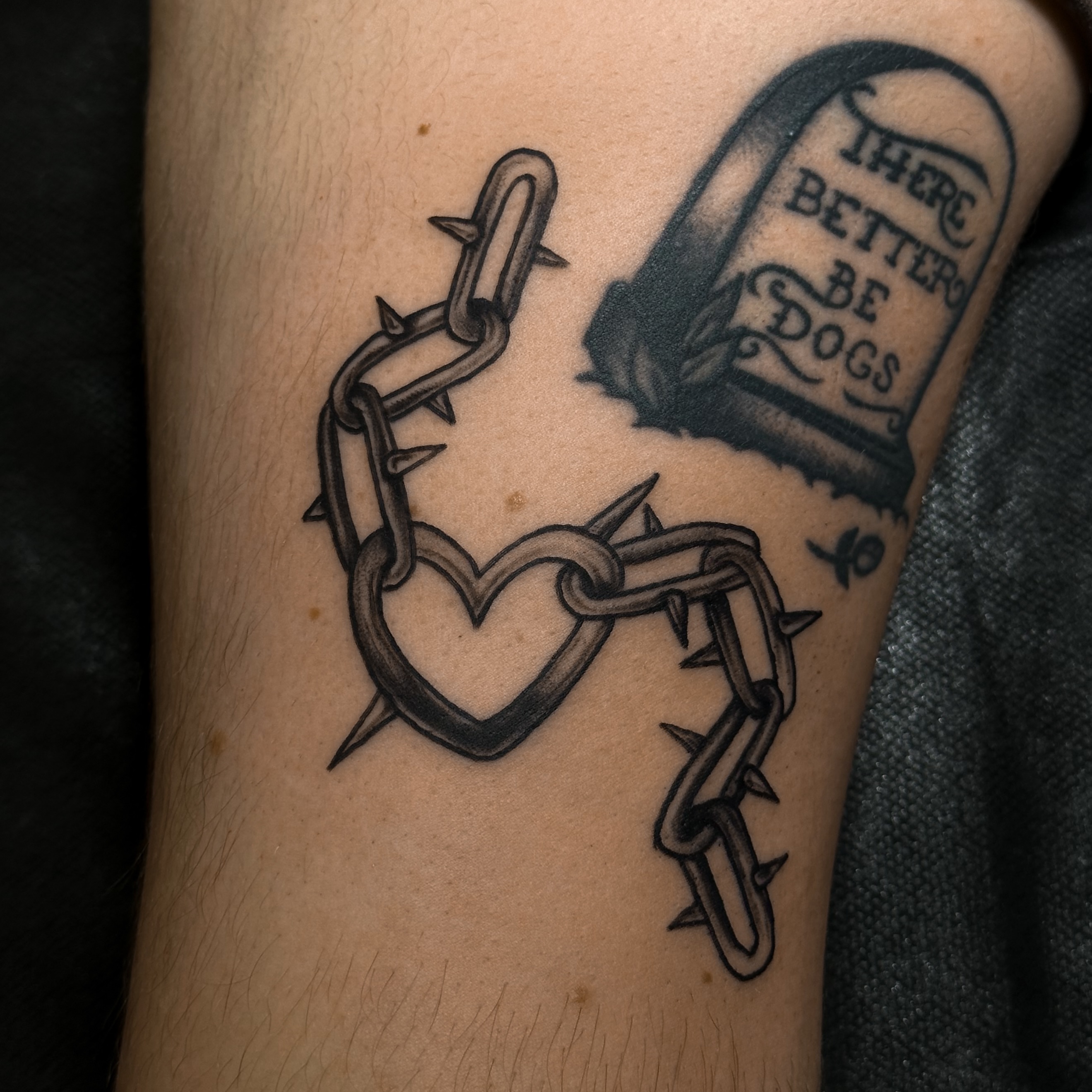 Barbed heart and chain black and grey tattoo on the forearm by Victoria