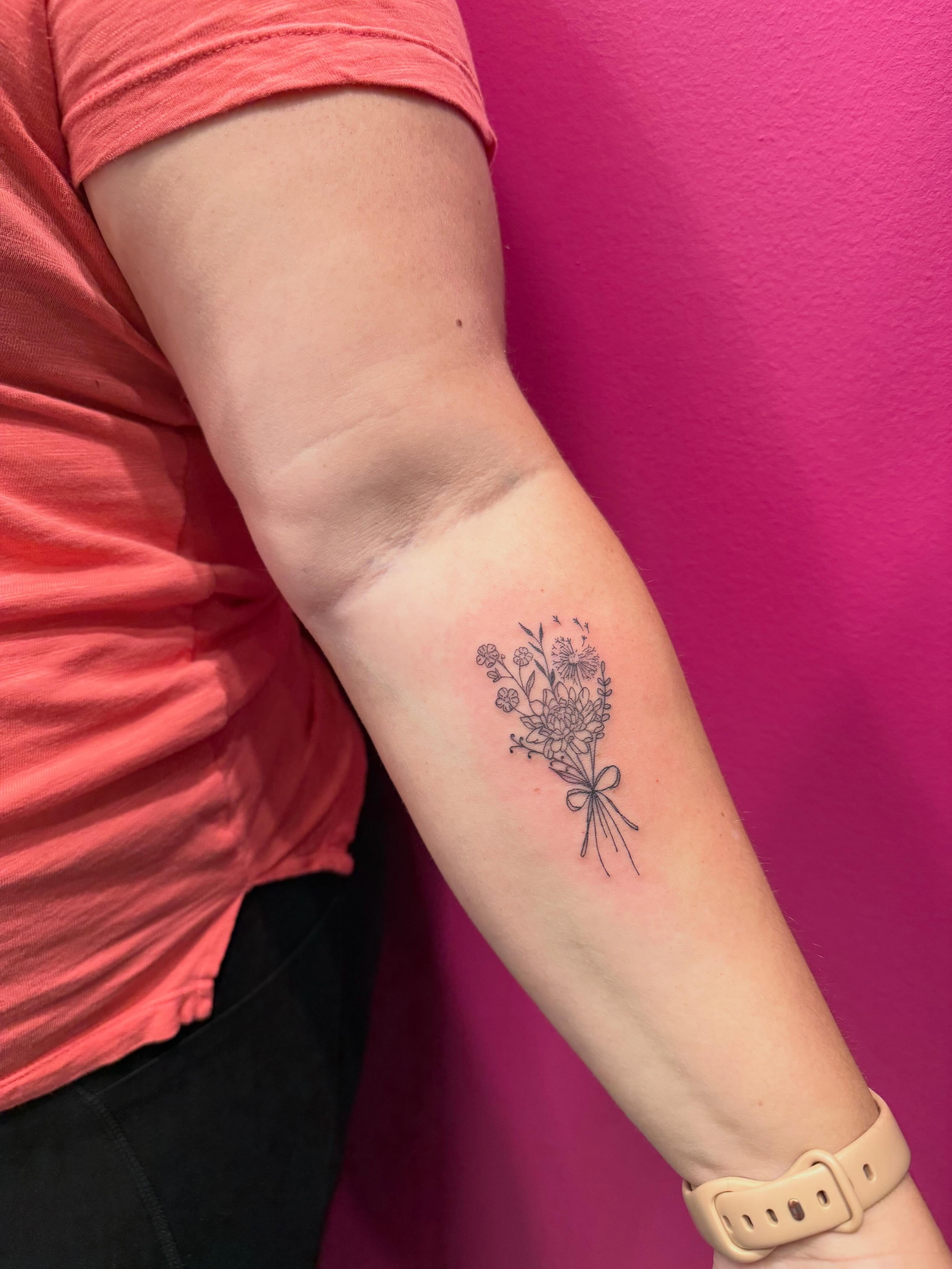 Flower bouquet black and grey tattoo on the forearm by fine line tattoos