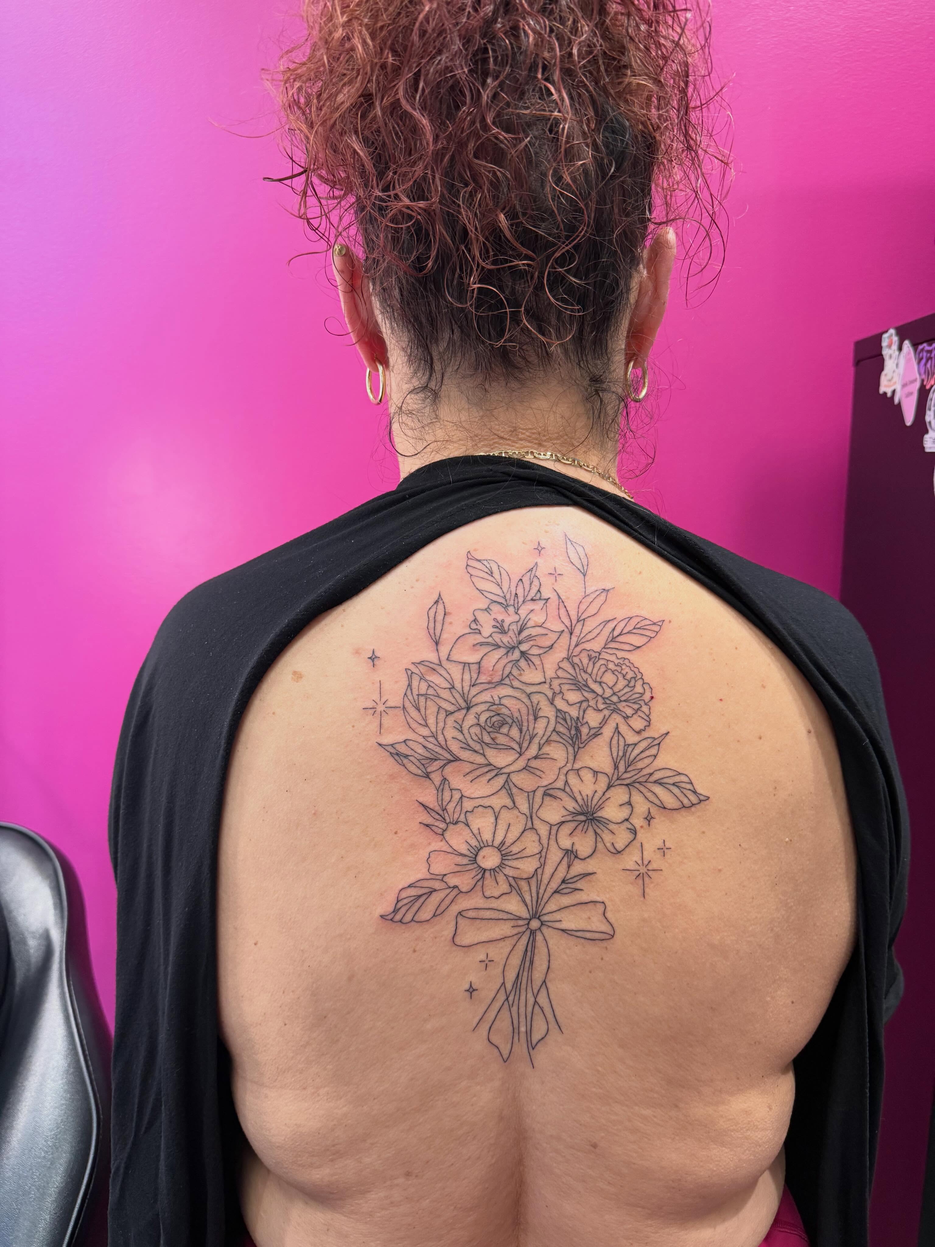 Flower bouquet black and grey tattoo on the back by fine line tattoos