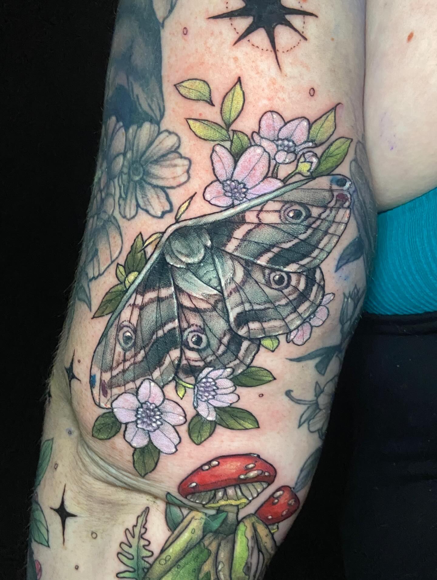 Butterfly and flowers American traditional tattoo on the forearm by Dawn Carr, Richmond, Virginia