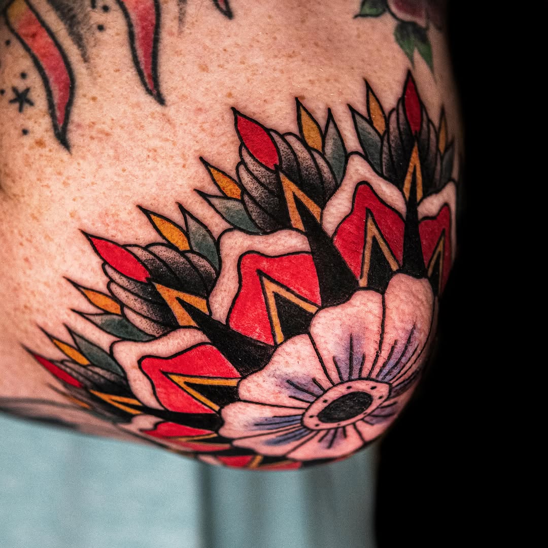 Floral design American traditional tattoo on the thigh by Danny Pando
