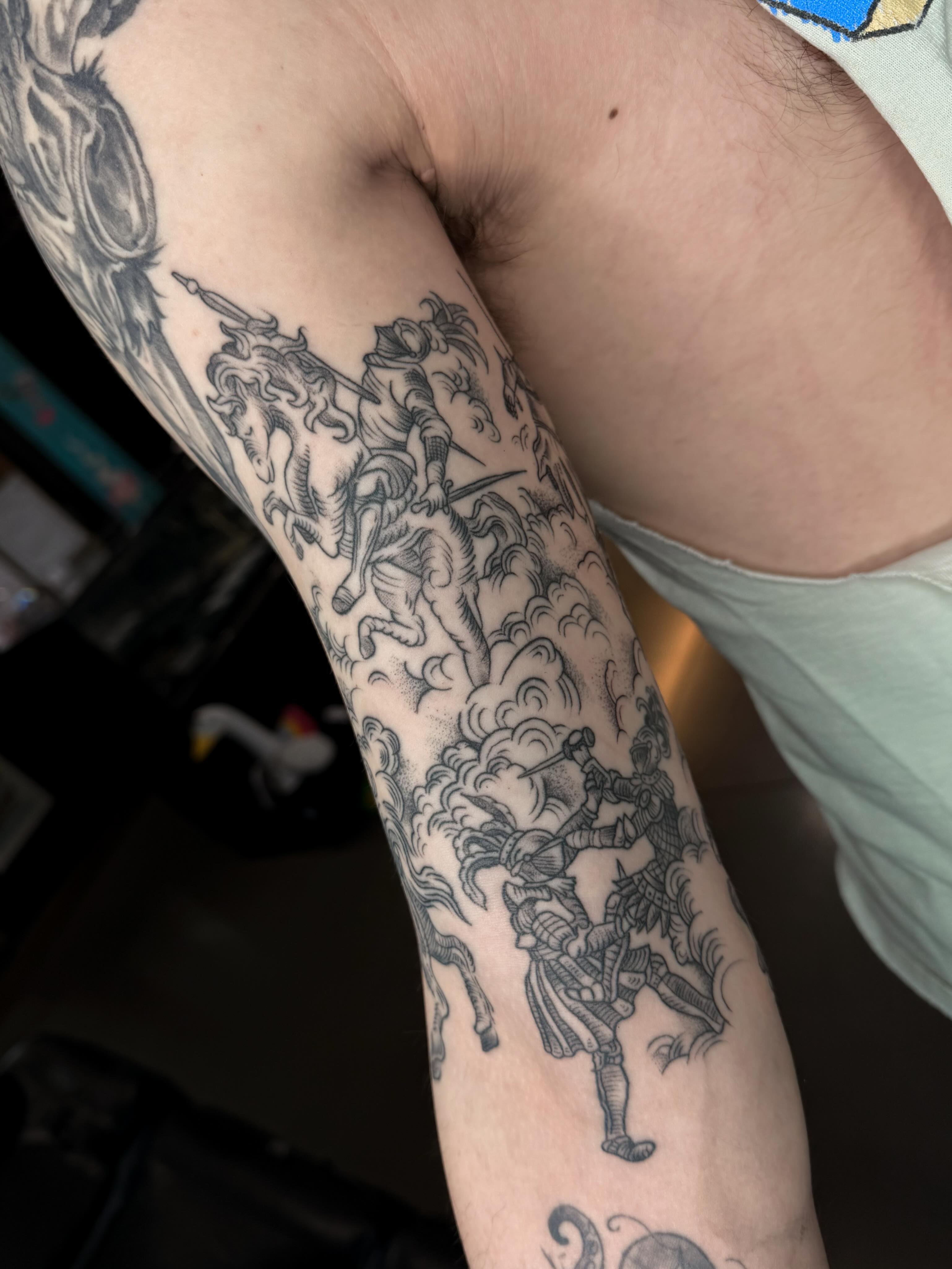 Horseman and dragon black and grey tattoo on the forearm by Susie Maj