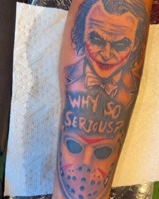 Joker and Jason Voorhees mask realism tattoo on the forearm by Marcus Carter