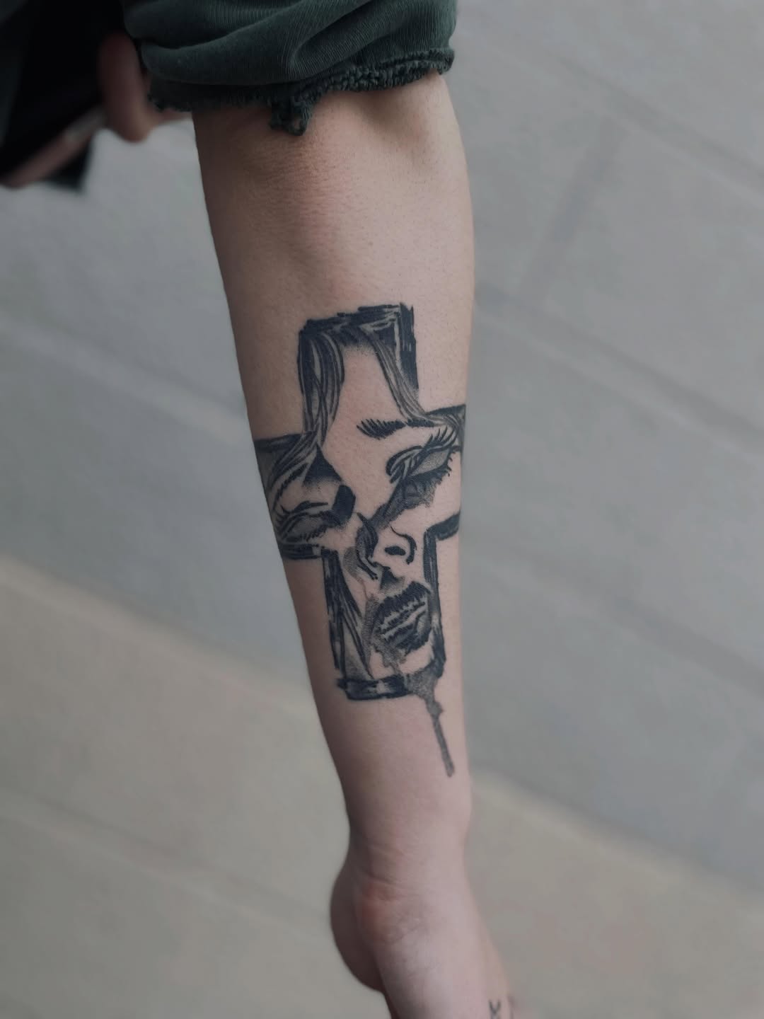 Face in a cross sketch tattoo on the forearm by Christien Xavier Alba, Salt Lake City, Utah