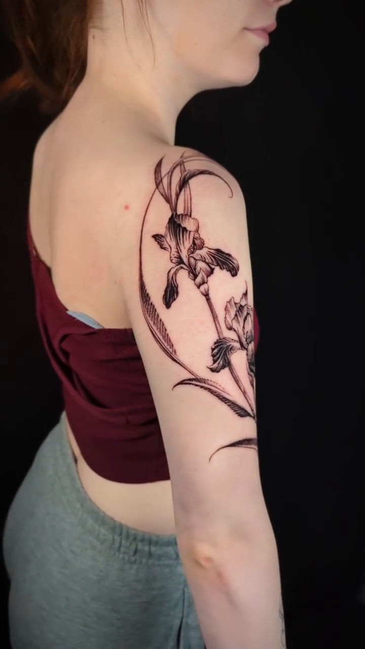 Irises and vine fine line tattoo by Jessica Sheahan
