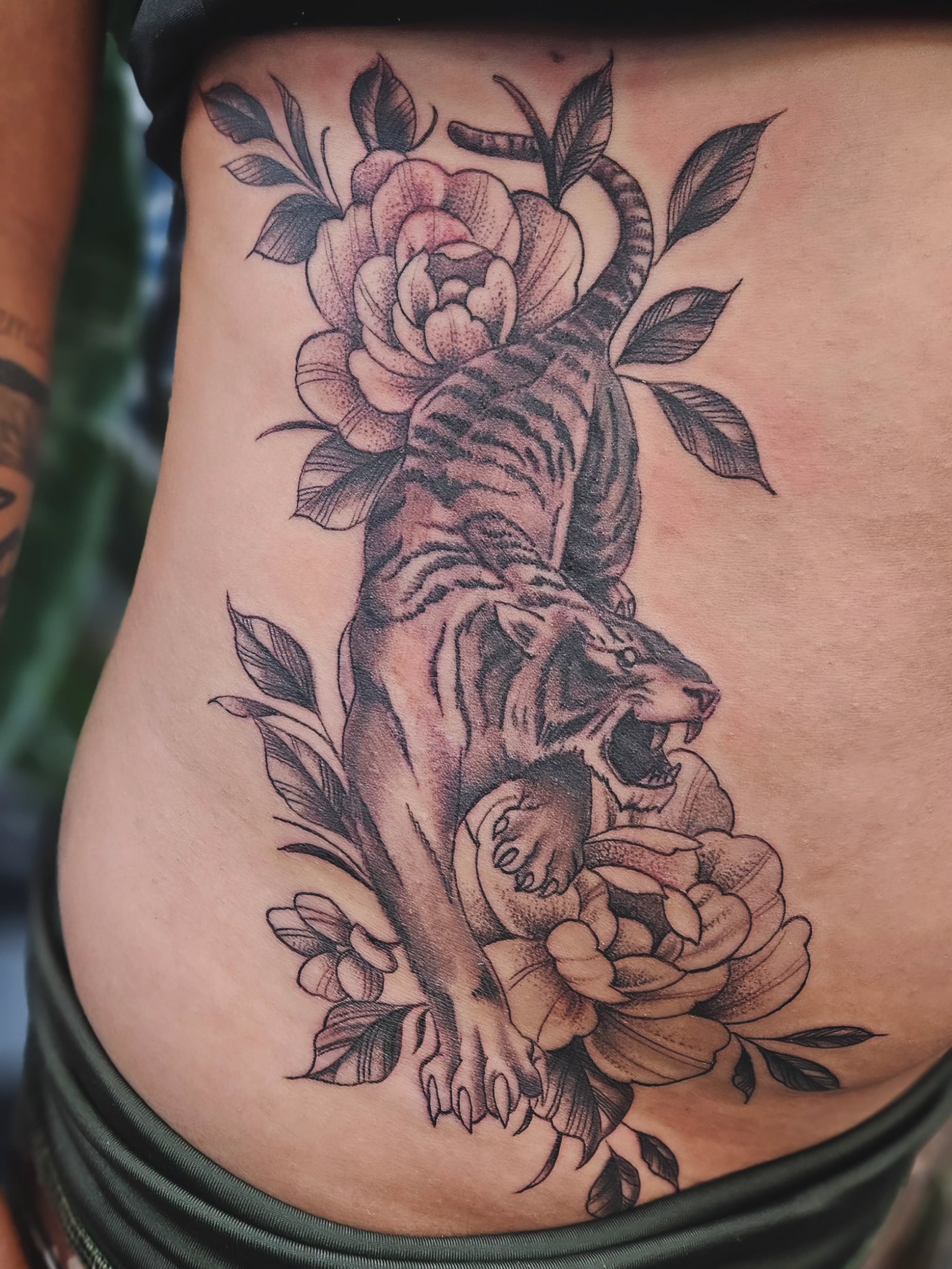 Tiger and roses American traditional tattoo on the thigh by Jo'el Acoba