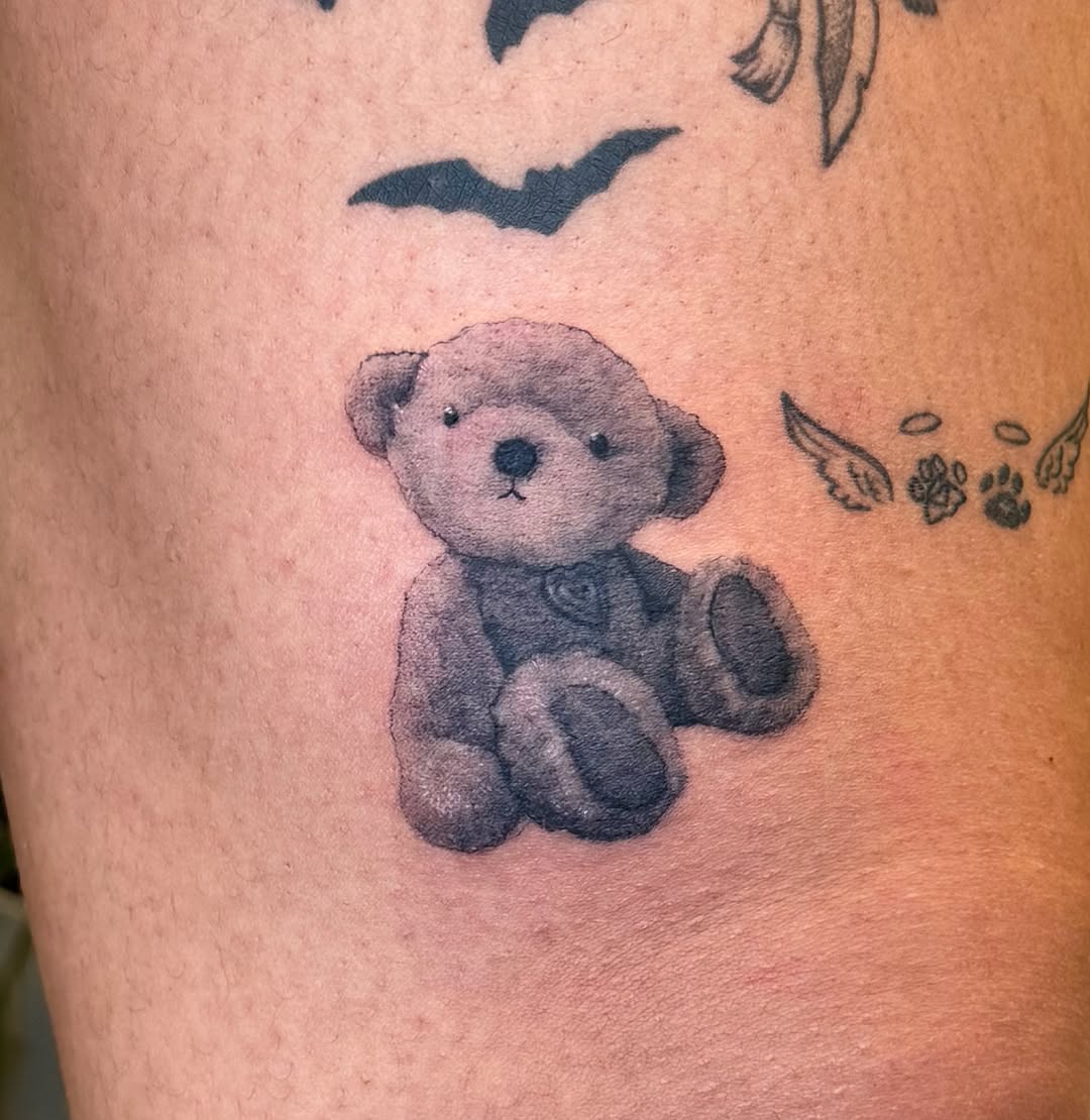 Teddy bear black and grey tattoo on the thigh by Xin Huang
