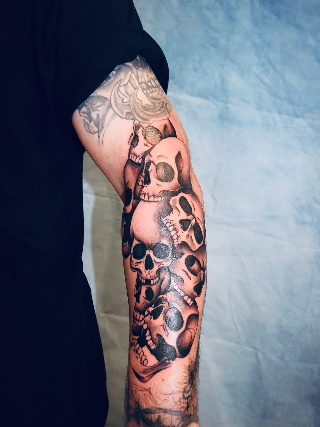 Pile of skulls realism tattoo on the forearm by π’ππ΅π΅π΄ π©°π