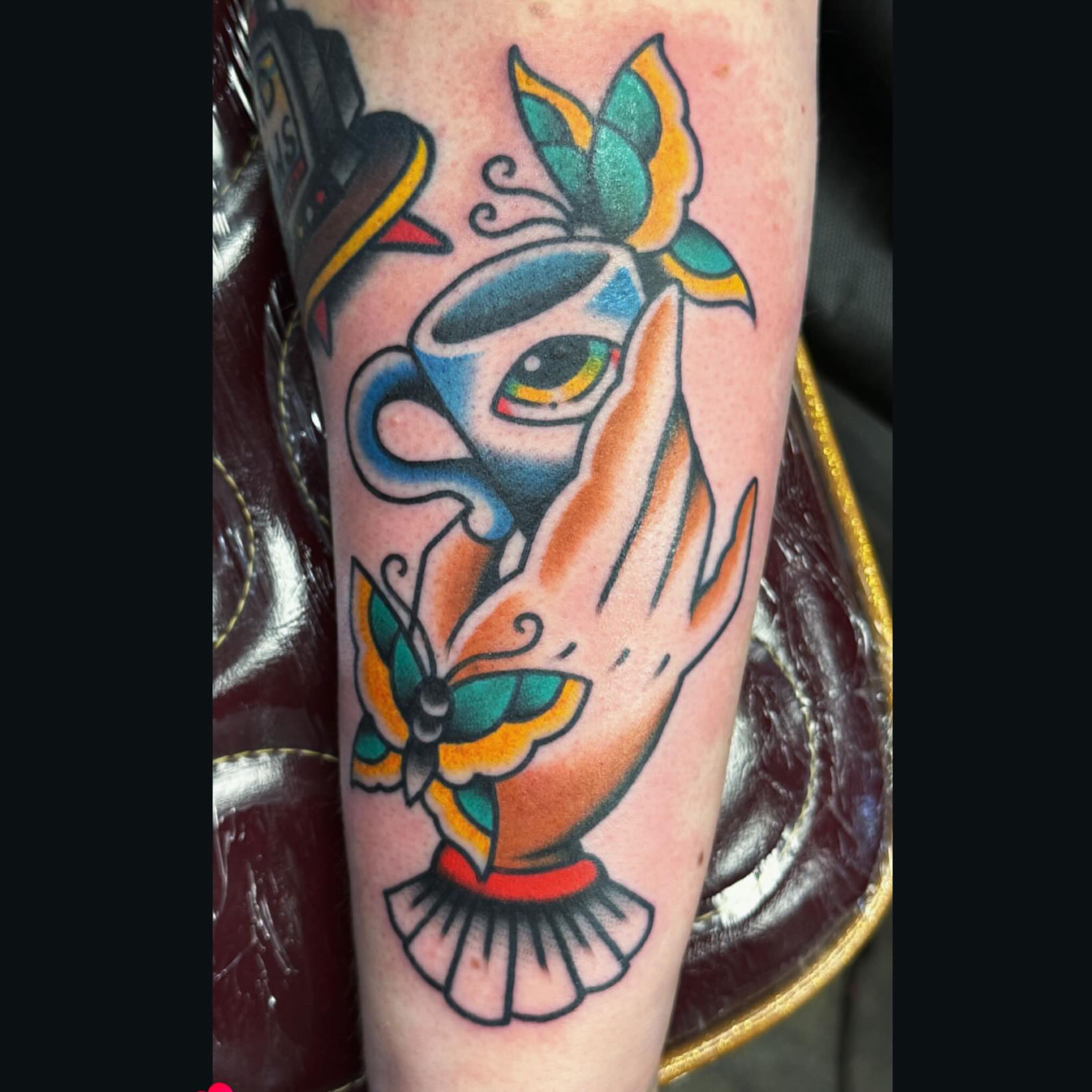 Hand holding coffee cup American traditional tattoo on the forearm by Big Al