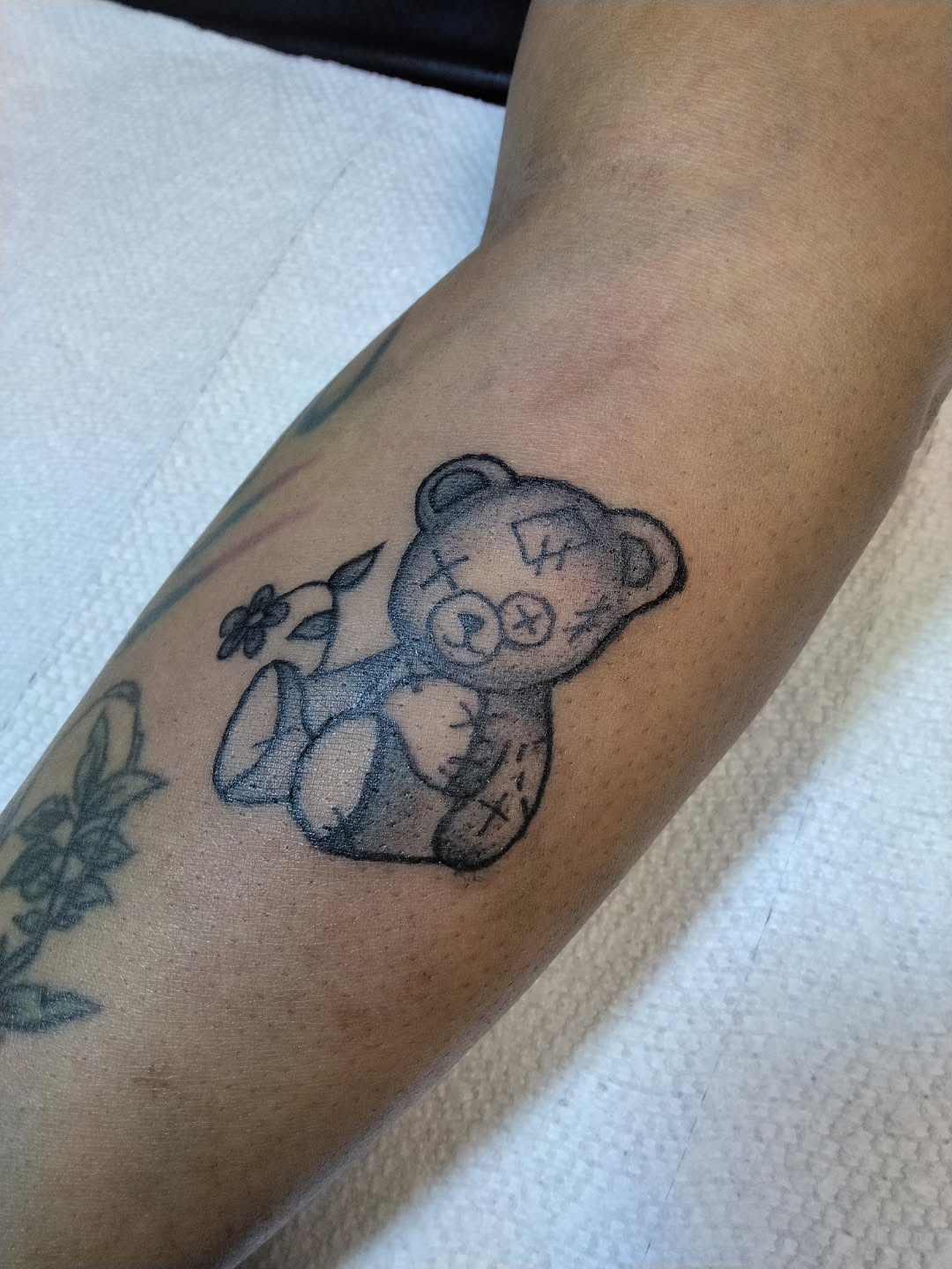 Teddy bear black and grey tattoo on the forearm by Malynda