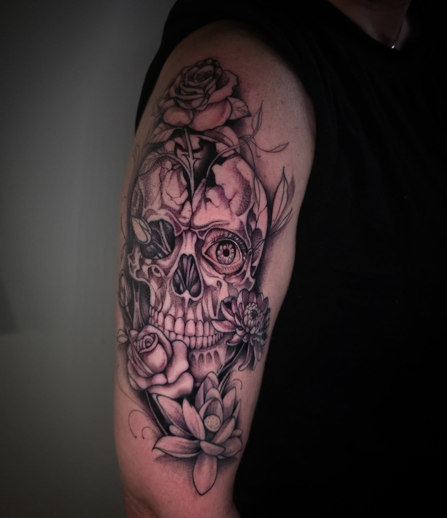 Skull with flowers realism tattoo on the upper arm by Matriix.Ink Tattoos, Groton, Connecticut