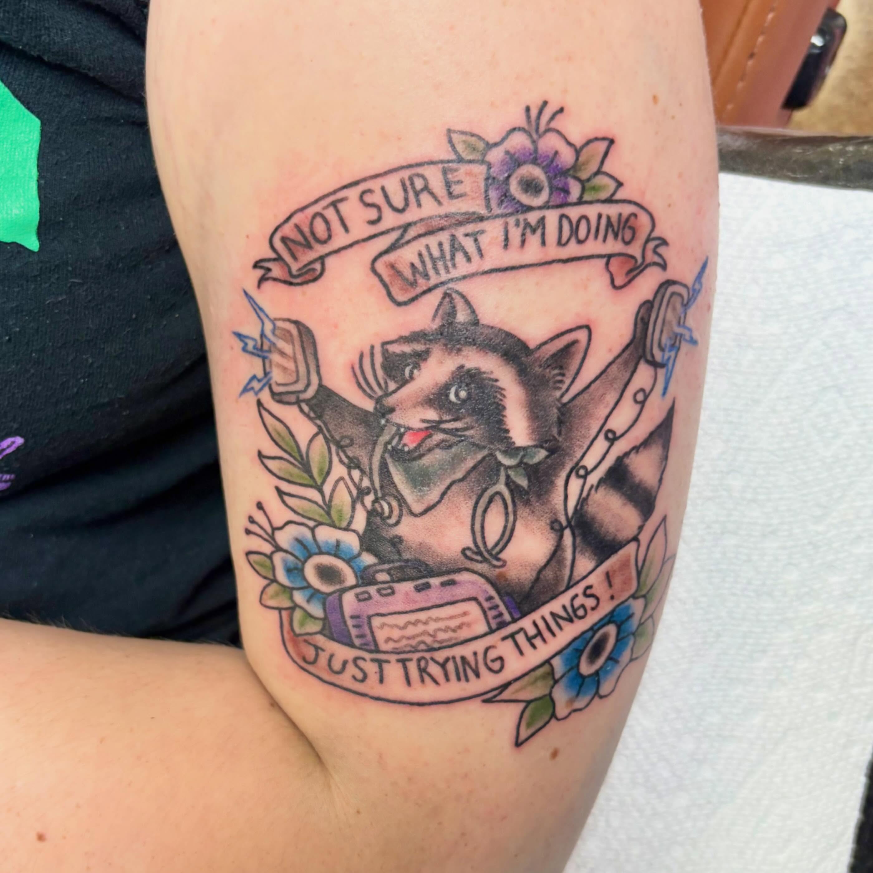 Raccoon with banner American traditional tattoo on the thigh by Gabby, Kansas City, Missouri
