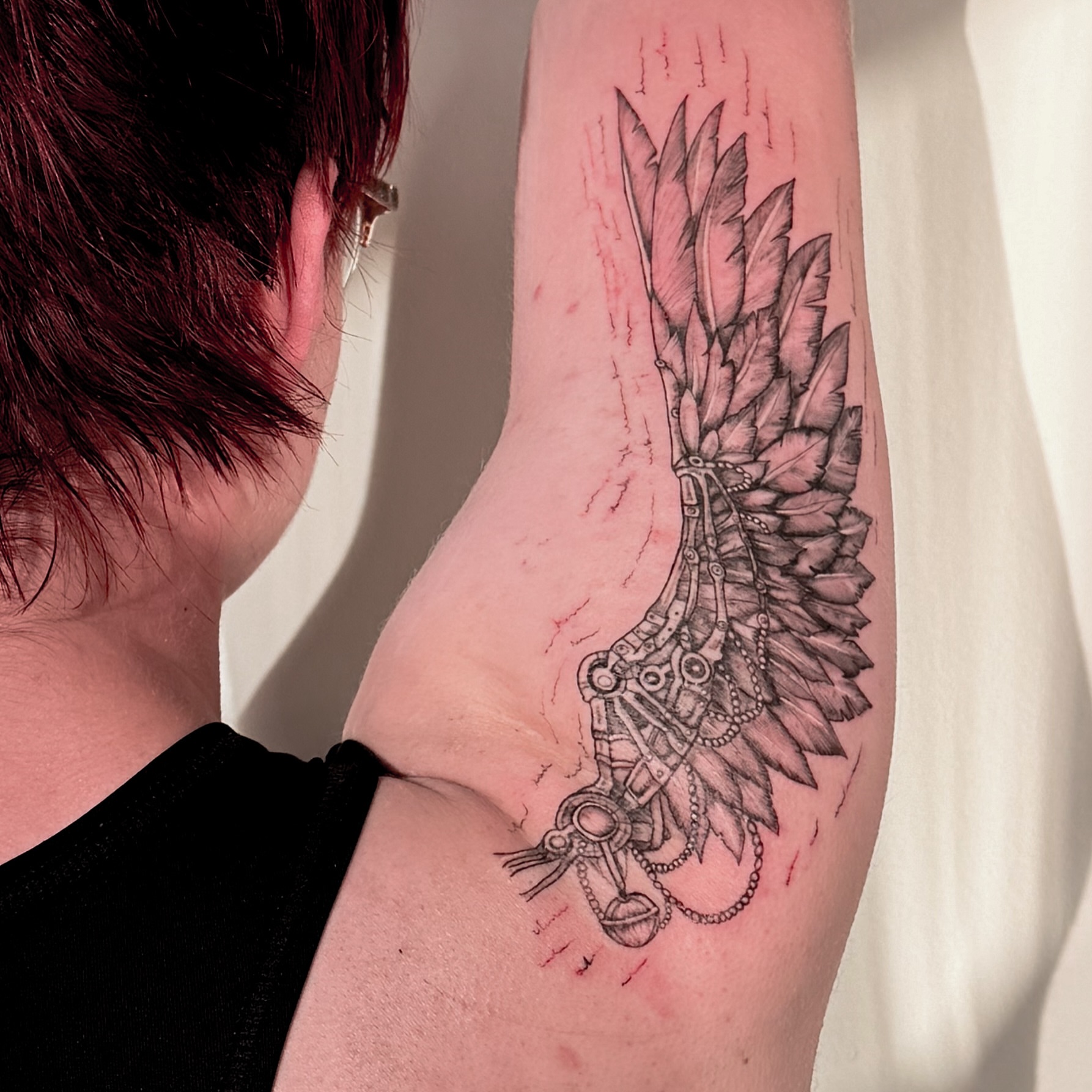 Mechanical wing geometric tattoo on the forearm by Tatuajes Denver