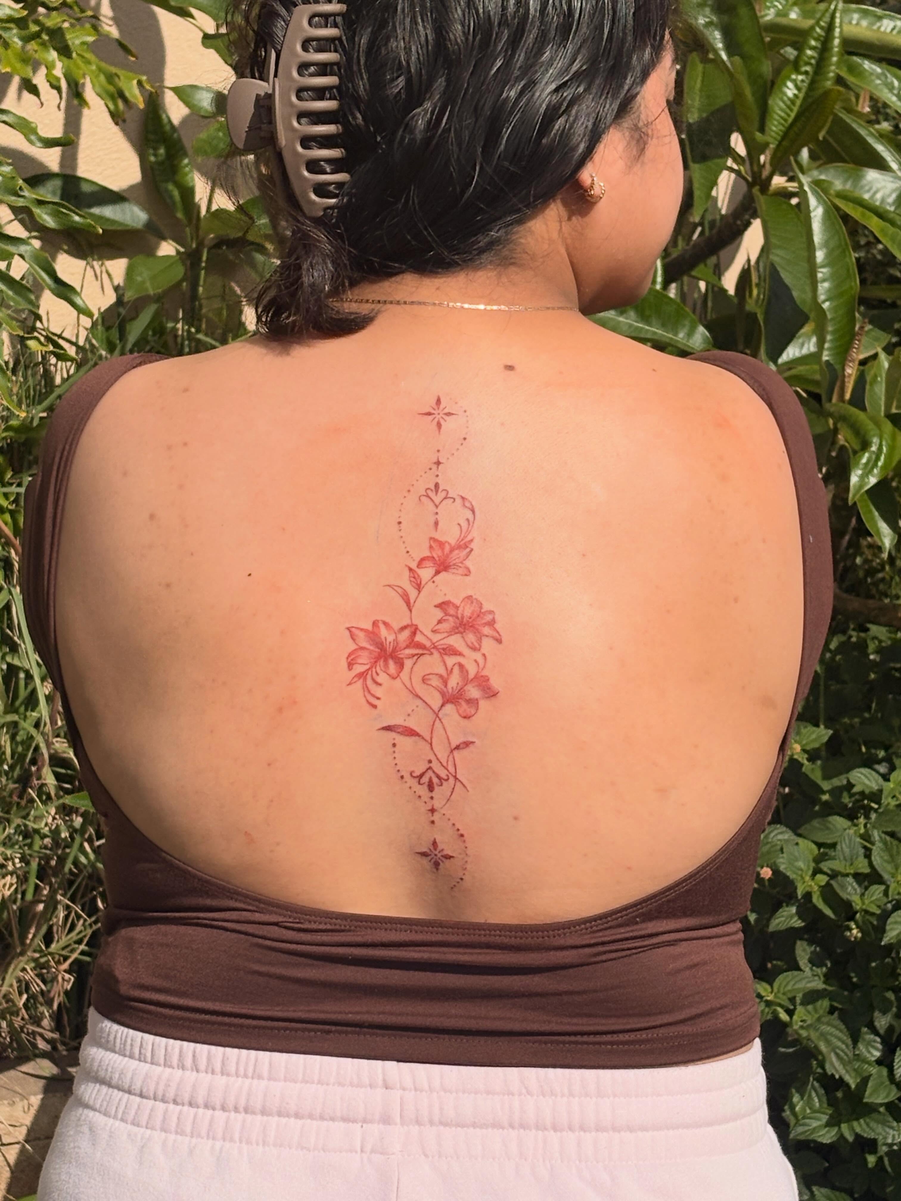 Lilies dotwork tattoo on the back by Tattoomobile
