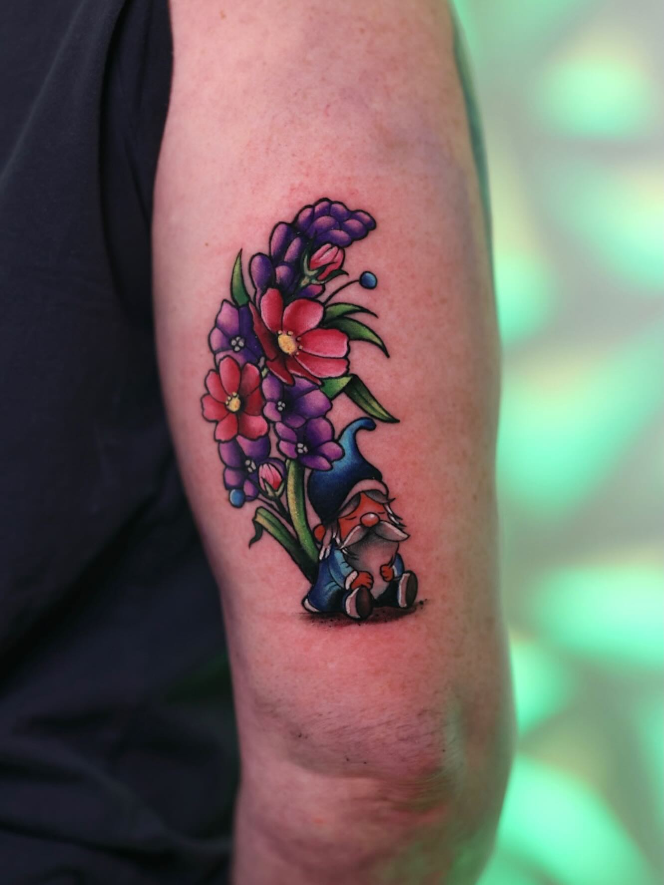 Gnome and flowers American traditional tattoo on the forearm by Haleigh Cunningham, Charlotte, North Carolina