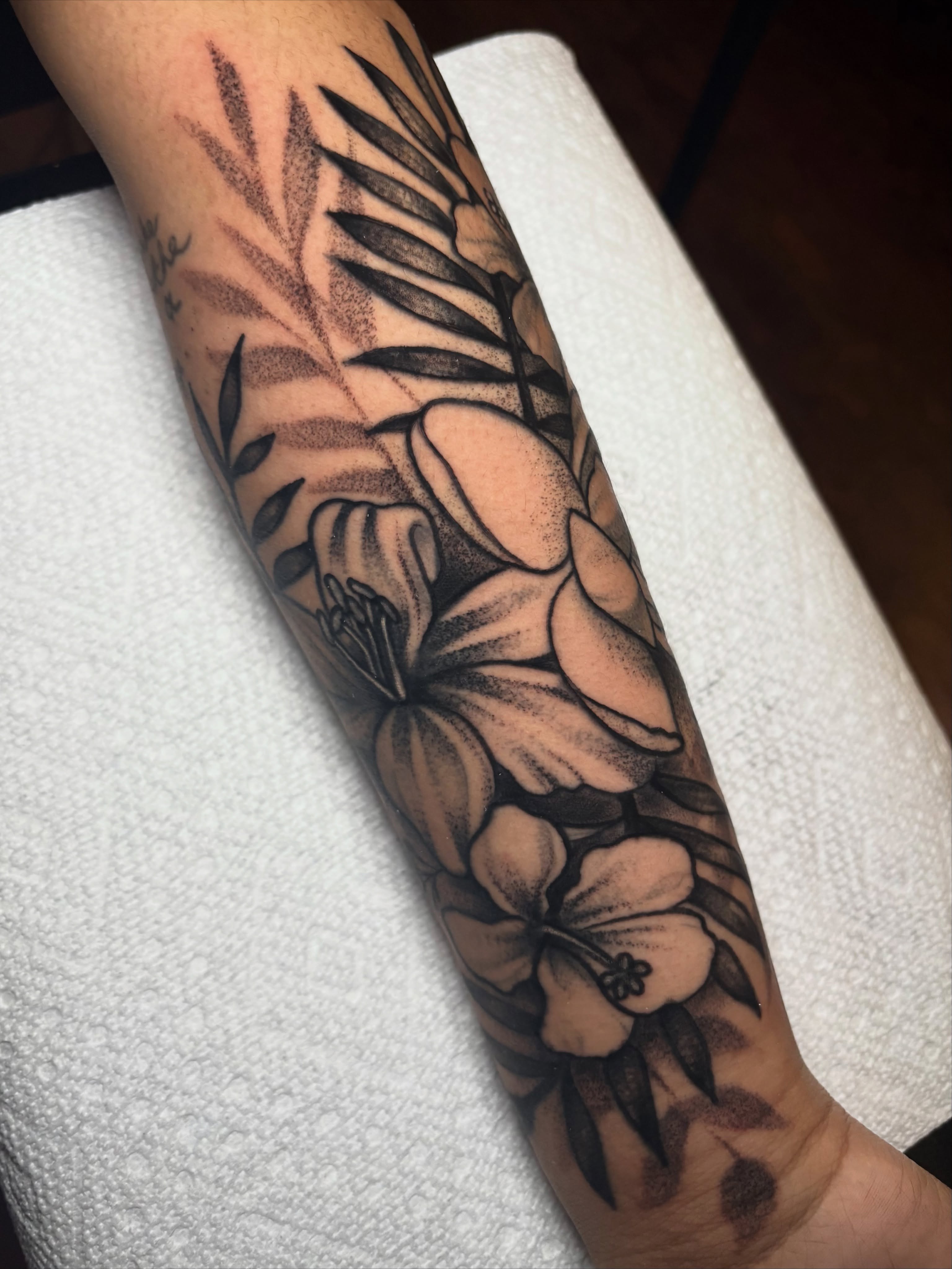 Hawaiian flowers and leaves dotwork tattoo on the forearm by Flor, Dallas, Texas