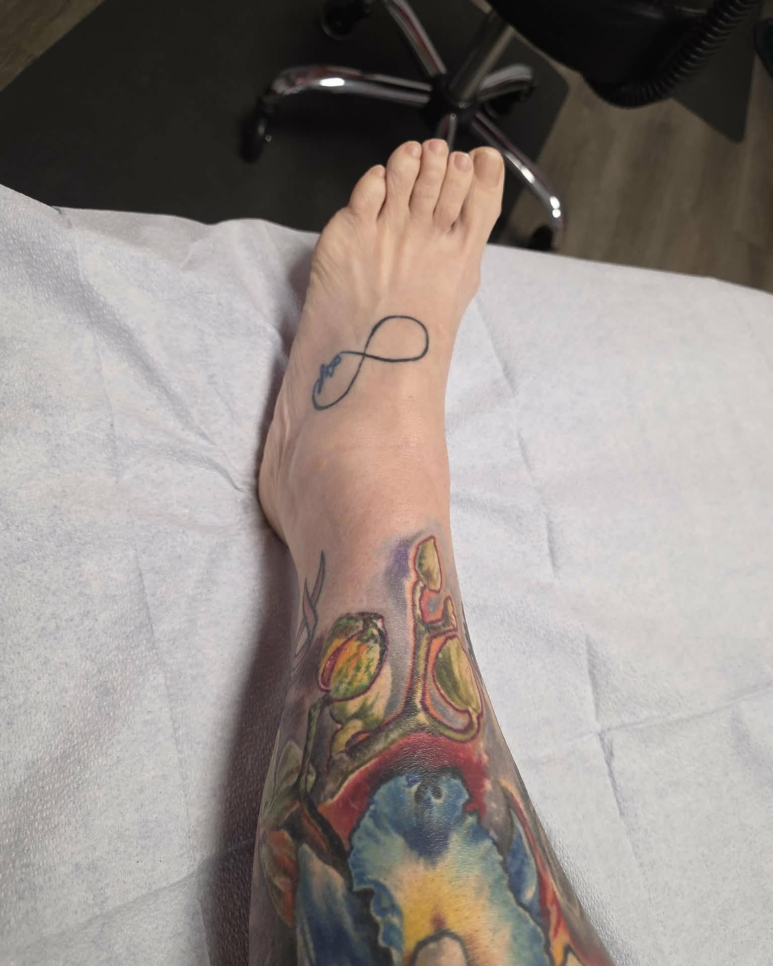 Infinity symbol dotwork tattoo on the foot by Gene Britton
