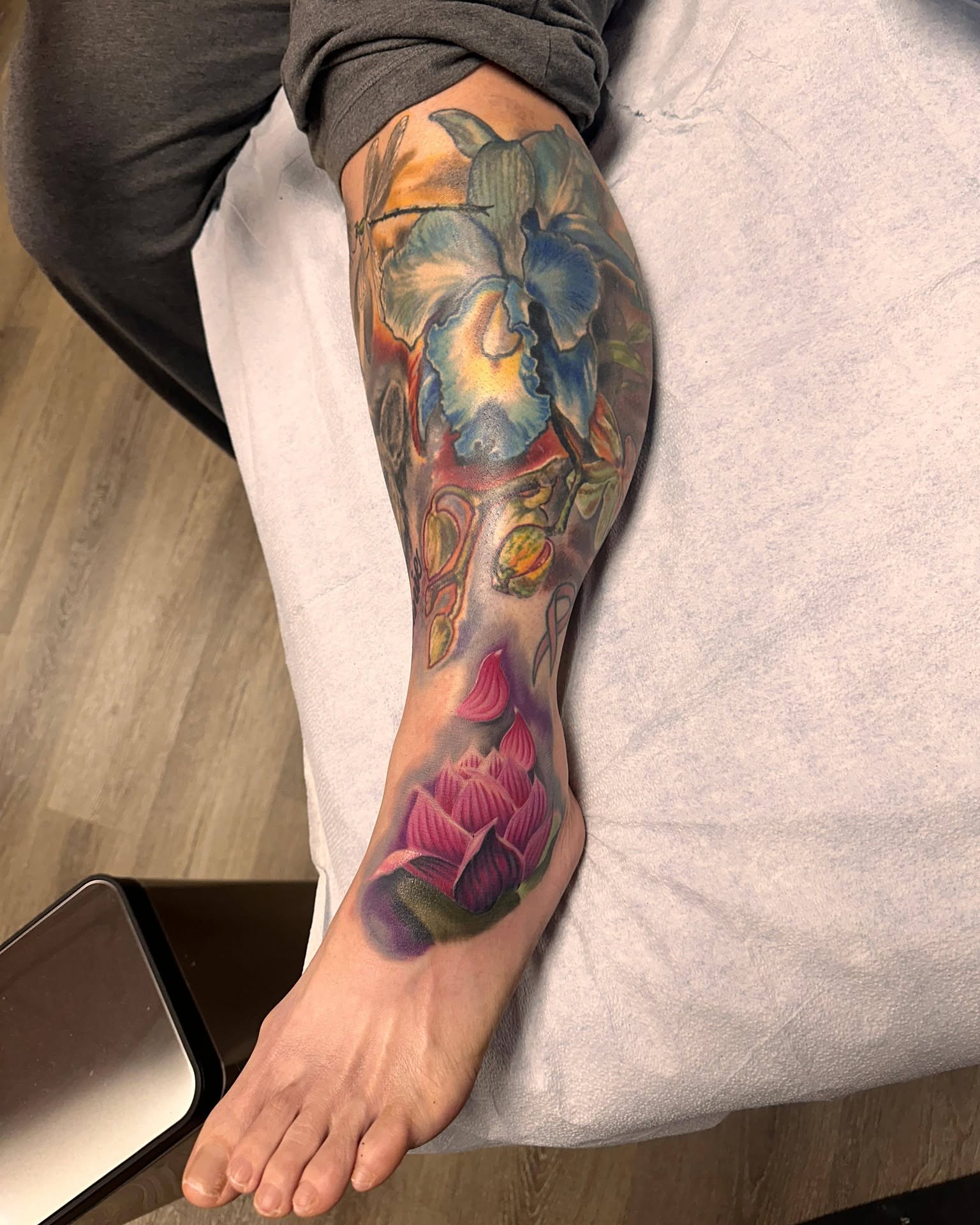 Floral arrangement realism tattoo on the calf by Gene Britton
