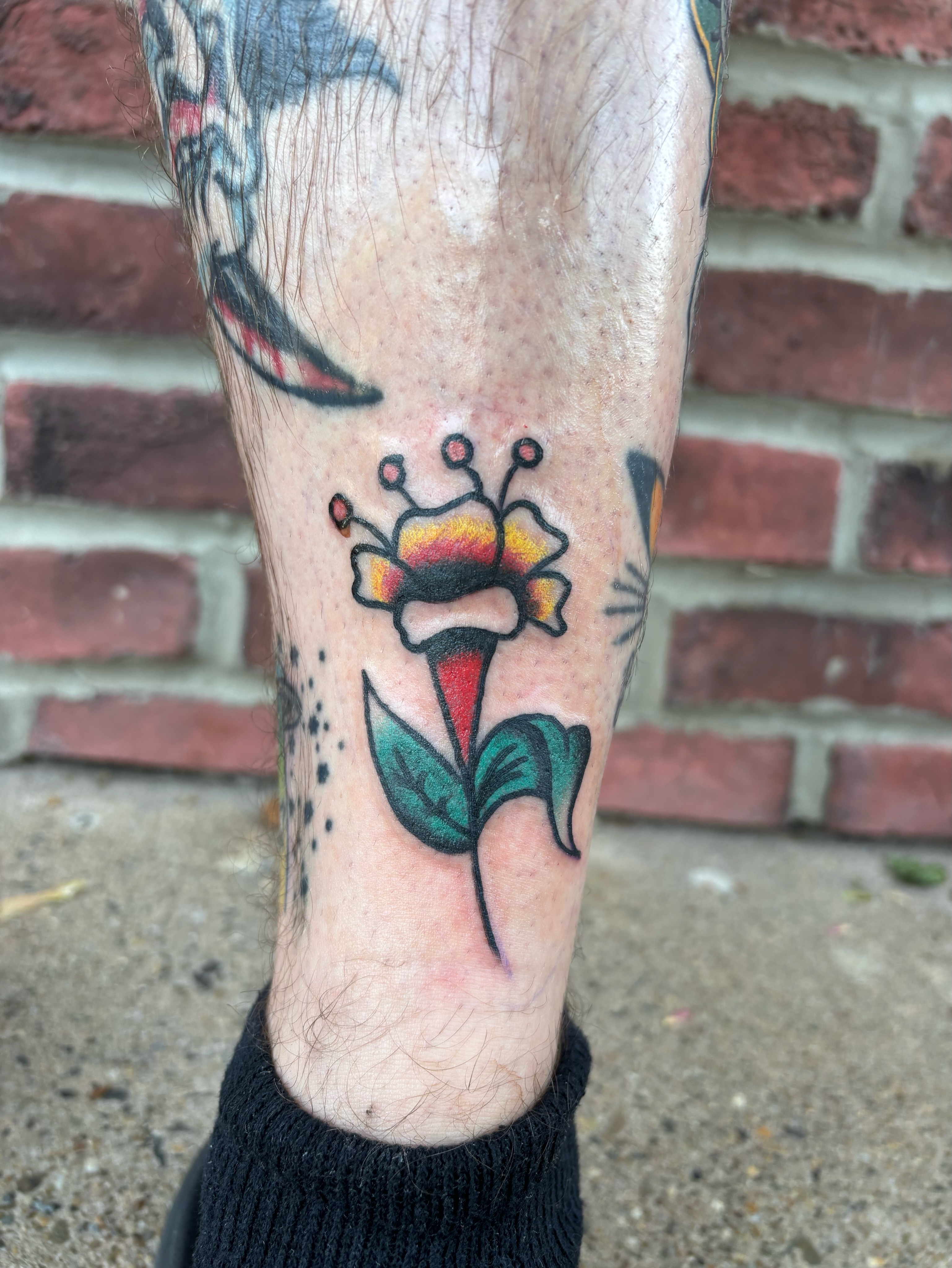 Flower American traditional tattoo on the forearm by Cooper Reichwein