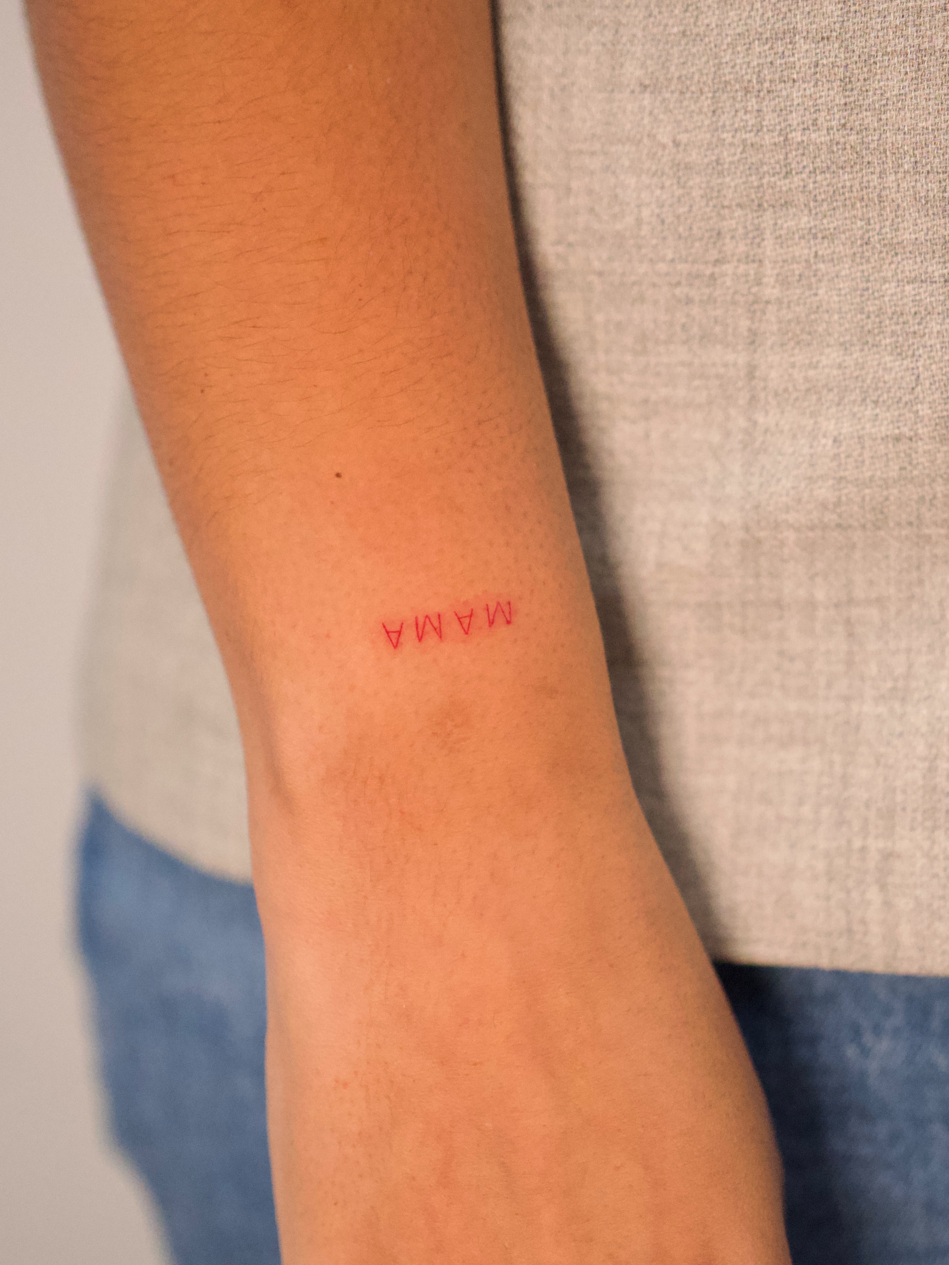 MAMA lettering script tattoo on the forearm by Tattoo fine line NY