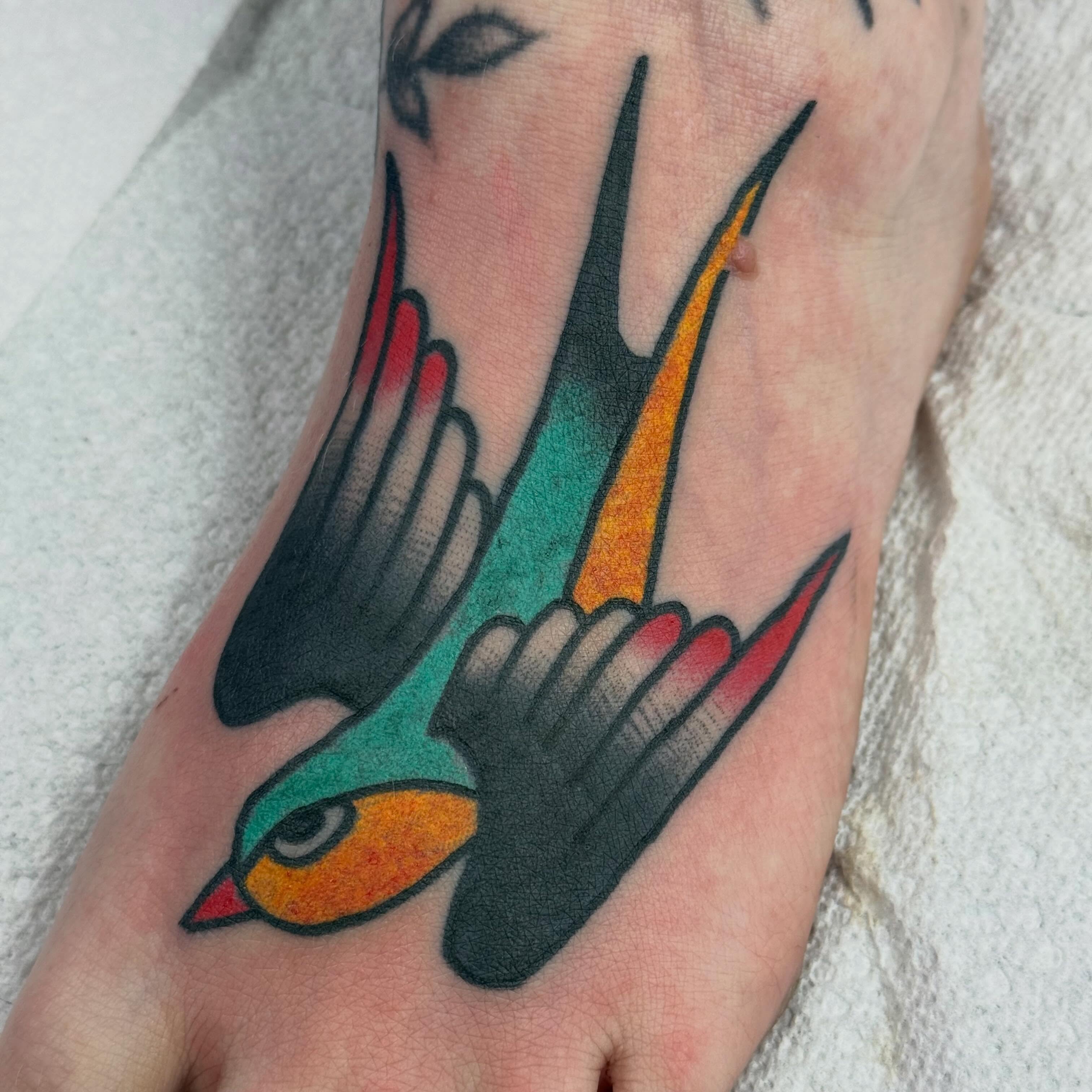 Swallow American traditional tattoo on the foot by Alexandria Green