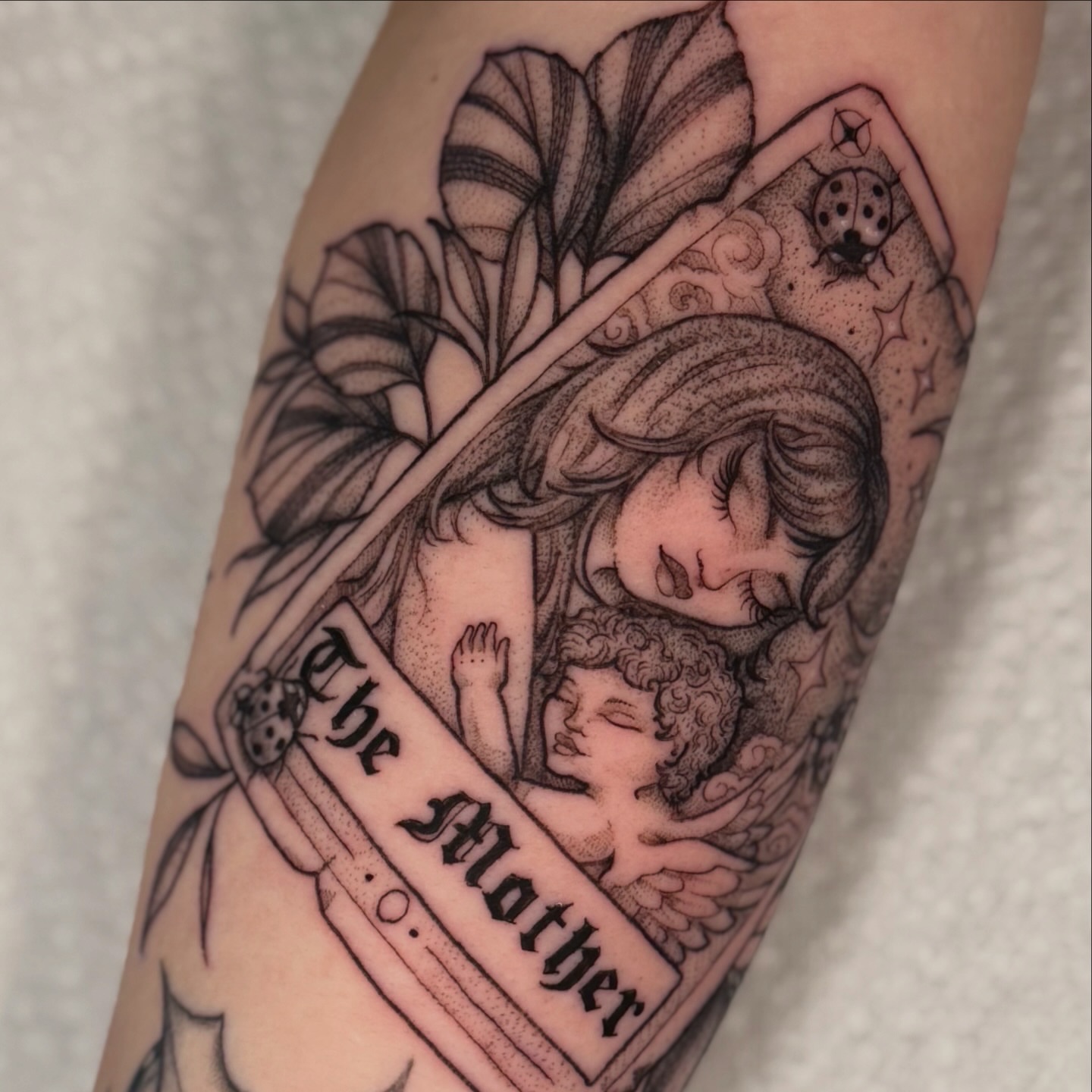 Mother and child realism tattoo on the forearm by Chiah