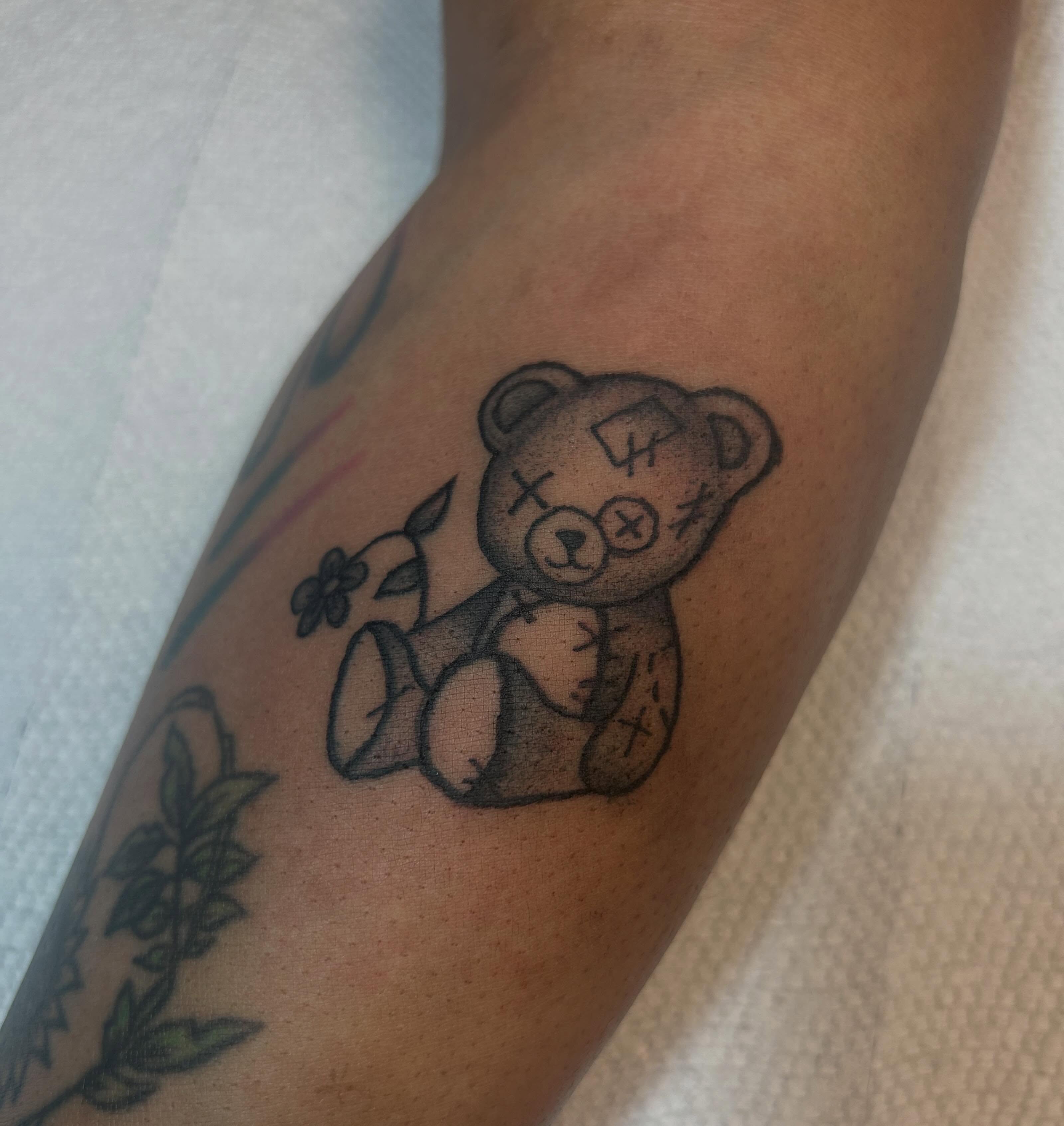 Teddy bear black and grey tattoo on the forearm by Malynda