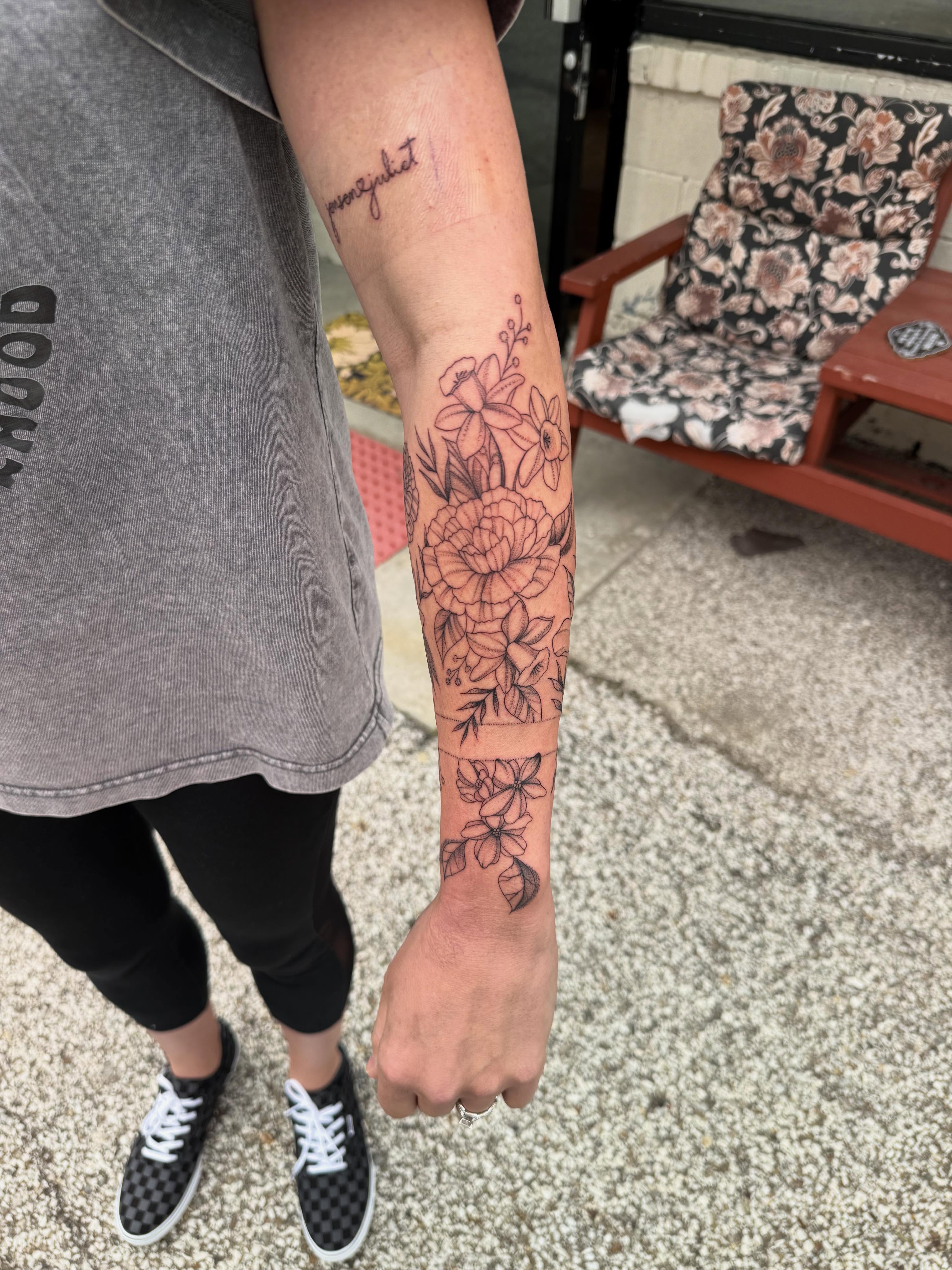 Floral bouquet black and grey tattoo on the forearm by Max