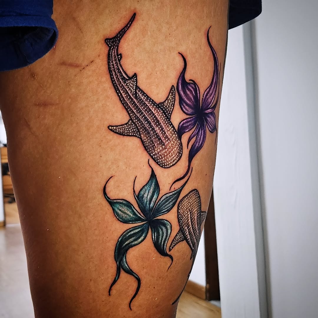Fish and flower dotwork tattoo on the leg by Isaac Morales
