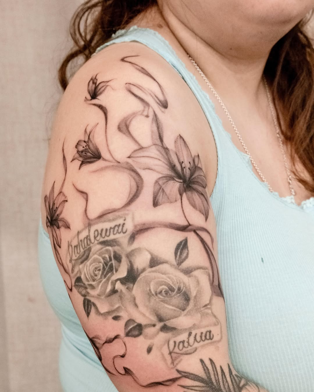 Floral arrangement realism tattoo on the upper arm by Koko