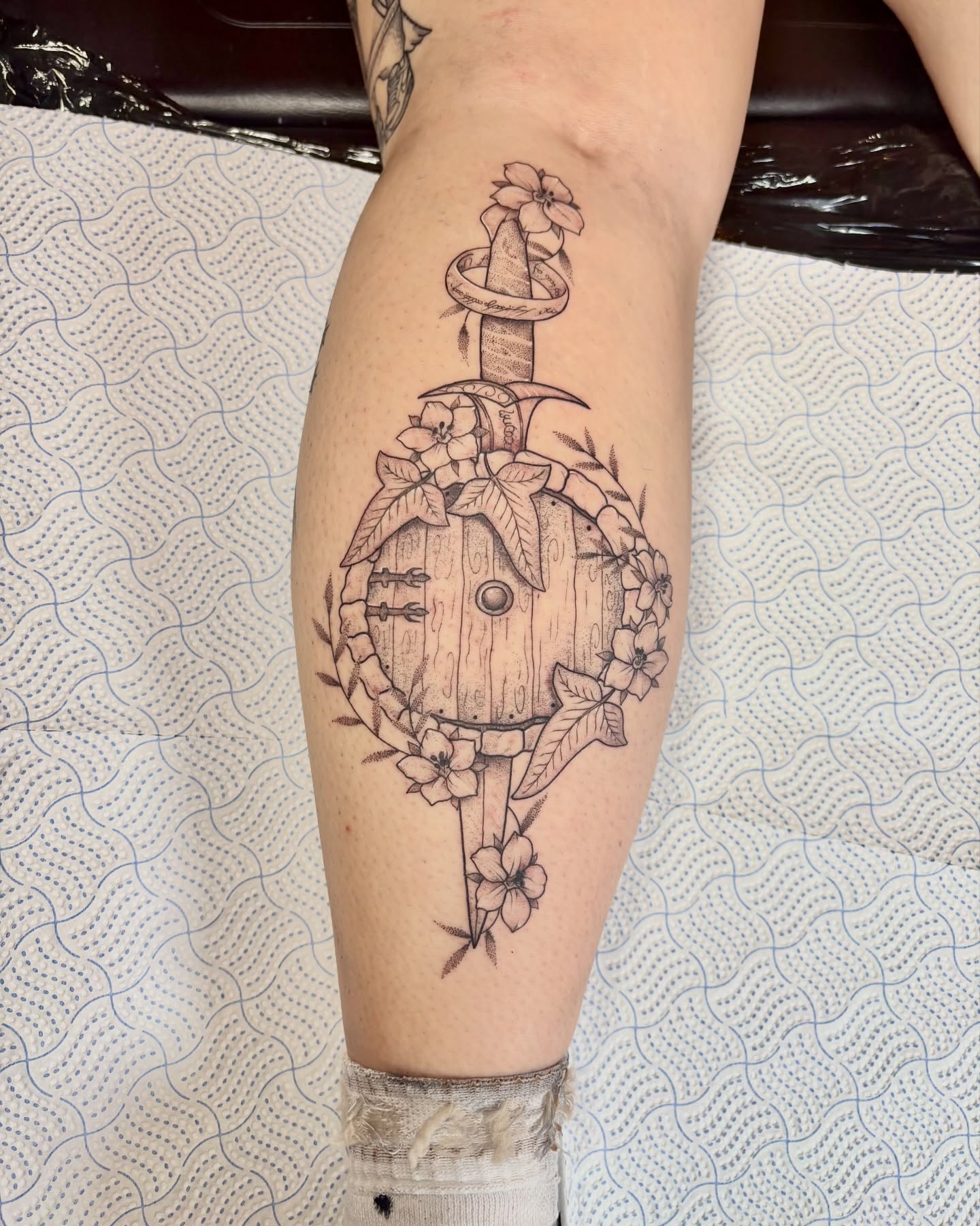 Wooden door with flowers geometric tattoo on the forearm by Charlotte Brown, Leeds, England